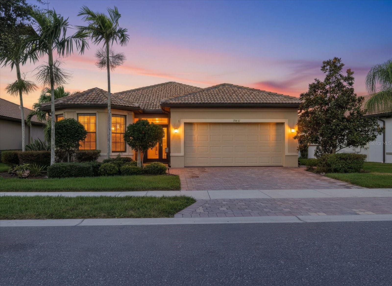 Enjoy spectacular western sunsets, peaceful water views, and exceptional privacy at this beautifully maintained Abbeyville home in IslandWalk! Offered by its original owners, this 2015 residence offers a special combination of an extended lanai, a private backyard setting, thoughtful upgrades, and an impressive list of improvements. The home features 2 bedrooms, 2 bathrooms, a versatile den/flex room, and a 2-car garage with a 4-foot extension and 2 overhead storage racks.

The open floor plan features upgraded tile flooring in the main living areas and baths, granite kitchen countertops, a stylish backsplash, convenient pull-out shelving in lower cabinets, and three distinctive pendant lights with hand-blown glass shades above the kitchen island. A custom-built butler's pantry adds valuable storage near the garage entry, while the den/flex room features newer luxury vinyl plank flooring. The primary suite offers a dropped tray ceiling, custom barn door separating the bedroom and bath, and an upgraded walk-in shower with a sliding glass enclosure. Additional details include comfort-height toilets, newer faucets in the kitchen and both bathrooms, and a foyer display shelf for plates or treasured collectibles.

The true highlight is the extended 12' x 20' screened lanai overlooking tranquil water and a grassy berm, with no homes directly behind. The western exposure creates a beautiful setting for enjoying Florida's spectacular sunsets, while the private view provides a welcome sense of seclusion. No-see-um screening and replaced lanai screen fasteners add to the outdoor enjoyment. The front porch is also screened, and the driveway has been widened for added convenience.

The original owners have taken a proactive approach to maintaining and protecting their home. The tile roof has been inspected annually, and roof vents were proactively replaced with galvanized aluminum vents in 2026. The entire exterior was painted and sealed in 2021. A whole-house generator connected to a 500-gallon propane tank was installed in 2023 and carries a 10-year warranty. Storm protection includes impact glass in three windows and hurricane curtains on the remaining windows and doors, including five motorized units with remote controls. Additional improvements include an insulated garage door, added attic insulation (R-8 added to the original R-12), and 2 overhead, garage storage racks.

Major updates include a new HVAC system and water heater in 2025, a new washer and dryer in 2025, and a new refrigerator in 2024. Additional improvements include an insulated garage door, added attic insulation, two ceiling-mounted garage storage racks, new coach lights in 2026, and an Alert 360 alarm system.

IslandWalk at West Villages is a gated, master-planned community spanning 830 acres, connected by scenic freshwater canals, walking paths and arched bridges reminiscent of Venice, Italy. Amenities include 12 lighted pickleball courts, 8 clay/Har-Tru tennis courts, 3 pools, 2 fitness centers, 6 bocce courts, event centers, dog parks, fire pits, an art room, community kitchens and a gazebo. A staffed guardhouse, abundant wildlife and picturesque walkways enhance this exceptional Florida lifestyle. Discover this special home in a truly distinctive community.