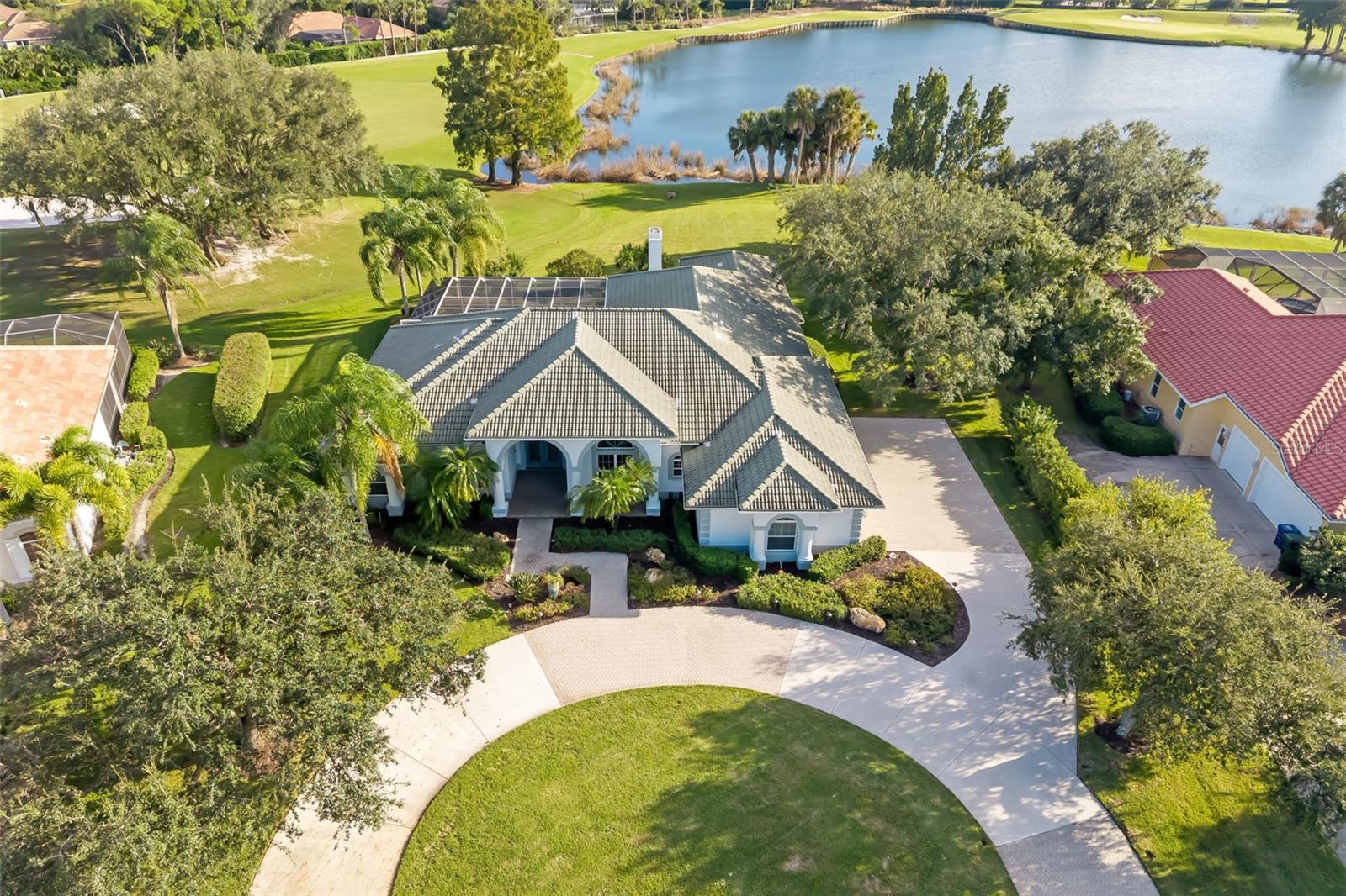 Virtually Staged. In prestigious Laurel Oak Estates, this custom-built residence offers an exceptional setting overlooking the lake and fourth fairway of the Signature Jones golf course! A circular driveway welcomes you to this impressive four-bedroom, 4.5-bath home, featuring a bright, open plan with natural lighting. Kitchen features stainless steel appliances complemented by a wet bar and built-in desk. Additional features include a 3.5-car garage plus an air-conditioned storage/golf cart garage. On an oversized lot of approximately 0.493 acres, the home features an outdoor living area designed for entertaining with a large pool, spa, outdoor kitchen and awning for shade. Inside, a spacious laundry center with abundant storage adds everyday convenience. Laurel Oak Country Club offers two signature golf courses, 12 Har-Tru tennis courts, pickleball and an active social calendar. Experience the beauty, privacy and lifestyle that make Laurel Oak Estates desirable.