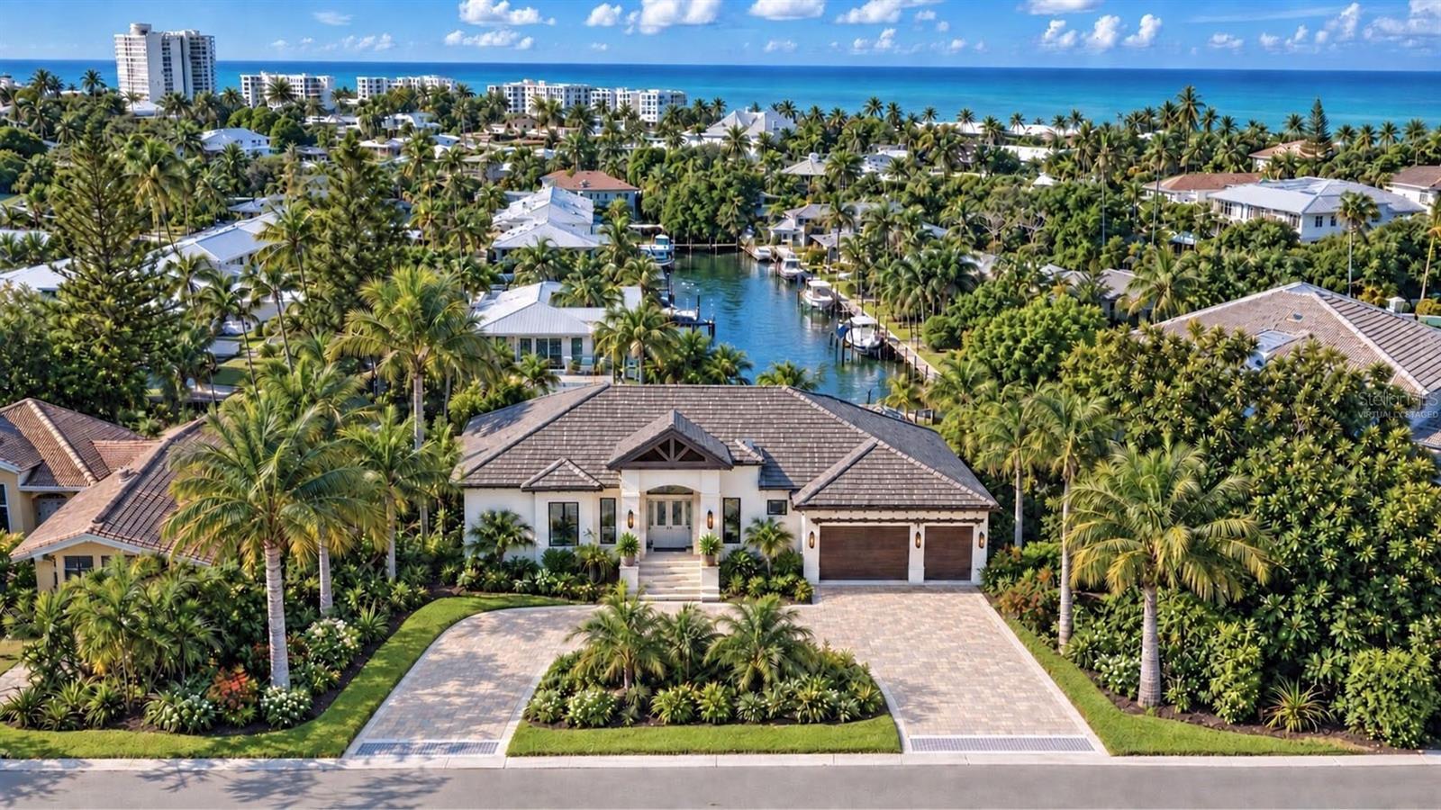 Pre-Construction. To be built. Expected to be completed in a few months, this new construction North Siesta Key residence blends innovative design, exceptional craftsmanship, and timeless coastal elegance. Designed and built by Pham Development, the home offers 3,482 square feet of living space and is nestled on a nearly 14,000-square-foot lot with 118 feet of prime canal frontage, a waterfront backyard, and a private boat dock. Featuring 4 spacious bedrooms, 4 full and 2 half beautifully appointed bathrooms, and a 3-car garage, this residence is thoughtfully designed for both comfort and style.

At the heart of the open-concept layout is a well-appointed kitchen featuring a stunning quartz island with waterfall edges, elegant pendant lighting, and sleek custom cabinetry. An exceptional appliance package includes a 72-inch Sub-Zero refrigerator, Cove dishwasher, and Wolf range, coffee maker, and microwave, making this space ideal for everyday living and entertaining. Light-filled living areas maximize the beautiful water views and provide a seamless connection to the outdoors.

Step outside to a private oasis, where a resort-style pool and lush landscaping create a tranquil retreat framed by swaying palms and shimmering waters. An outdoor kitchen provides the perfect setting for alfresco dining and entertaining. A private boat dock with a 10,000-pound lift and seating area invites days on the water and relaxed evenings along the canal. Located in one of Sarasota’s most desirable neighborhoods, just a short distance from world-class beaches, fine dining, and entertainment, this extraordinary property offers an exceptional blend of privacy, convenience, and waterfront luxury.