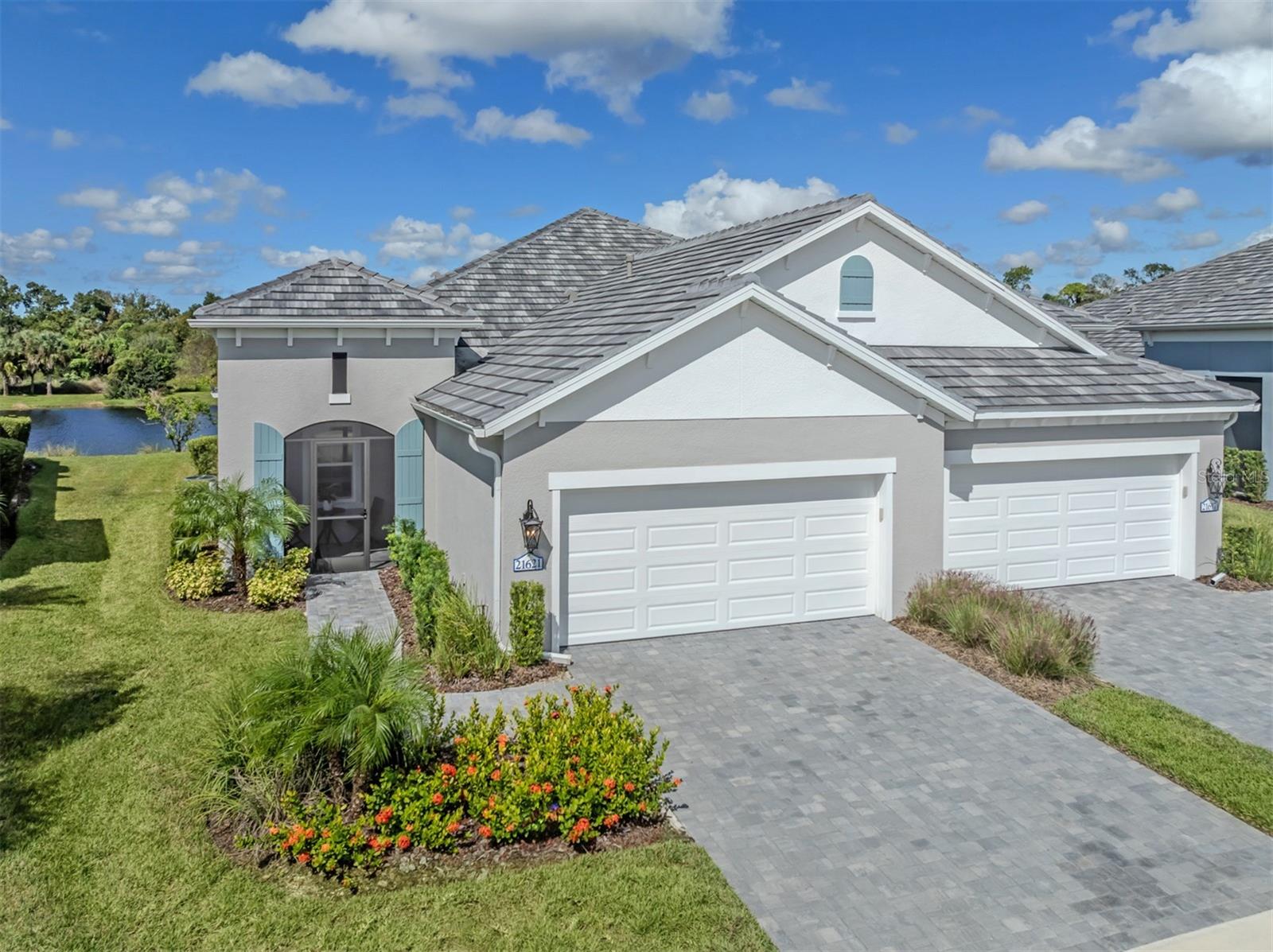Welcome to this beautiful Sandcastle two-model villa, ideally situated on a premium homesite overlooking a tranquil lake and preserved within the amenity-rich community of Grand Palm. Embrace a luxurious lifestyle in this thoughtfully designed three-bedroom, two-bath home with a den. From the inviting screened front porch to the extended lanai, complete with a 360-degree bronze Clearview screen enclosure, you’ll appreciate the seamless integration of indoor-outdoor living and the opportunity to take in the natural beauty of the lake and preserve beyond. Neutral wood-grain tile flooring, high ceilings, and refined finishes flow throughout the open-concept design. The gorgeous kitchen features a massive center island, upgraded pendant and dining-area lighting, a pantry with a closet organizer, quartz countertops, and a complementary tile backsplash. Perfect for family gatherings and entertaining friends, the kitchen opens to the great room, highlighted by a tray ceiling, a new ceiling fan, and pocketing sliding glass doors that fully open to the expansive lanai and breathtaking views. The primary suite offers serene lake views, creating a peaceful retreat to unwind and relax. A custom-designed walk-in closet provides exceptional organization and storage, while the spa-inspired en suite bath features dual vanities and a spacious walk-in shower. The split-bedroom floor plan provides added privacy, with two guest bedrooms and a second full bath situated separately from the primary suite. French doors open to a versatile den, ideal for a home office or additional flex space. An epoxy-finished floor in the two-car garage adds a practical finishing touch to this home, where everyday comfort meets elegant style. Grand Palm’s outstanding amenities enhance everyday living and include two clubhouses, multiple pools with waterslides, a fitness center, tennis and pickleball courts, volleyball and basketball courts, more than 10 miles of trails, and so much more. Just minutes from the gorgeous Gulf Coast beaches, Wellen Park, and Venice Island, you’ll enjoy the best of both worlds: a modern, amenity-rich community and the timeless charm of coastal living, with inviting restaurants, boutique shopping, outdoor recreation, and a vibrant local atmosphere. Discover the perfect blend of scenic surroundings, a vibrant community, and effortless Florida living in this exceptional Grand Palm villa; your opportunity to enjoy the lifestyle you’ve been dreaming of.