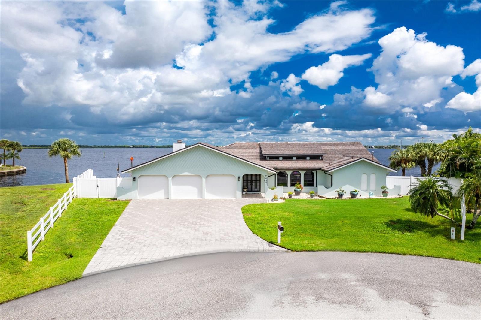 MYAKKA RIVERFRONT LUXURY*TIP LOT*HEATED POOL*SPA*DOCK*16,000 LB BOAT LIFT*EVERYTHING INCLUDED Experience luxury, tranquility, and the ultimate Florida waterfront lifestyle in this exceptional Myakka Riverfront home, perfectly positioned on a coveted tip lot with breathtaking water views and easy boating access to Charlotte Harbor and the Gulf of America.This home is offered fully turnkey, including all furnishings and décor. Simply move in and enjoy the Florida lifestyle! A 2023 composite cedar shake roof with a 50-year warranty, extra-wide paver driveway, 3-car garage with impact-resistant doors, and new interior and exterior paint welcome you home. Inside, modern tile flooring flows throughout the main living areas, while luxury vinyl plank flooring in the bedrooms provides style and easy maintenance. The open living and dining area features vaulted ceilings, abundant windows, and hurricane-rated skylights that fill the home with natural light. The beautifully upgraded kitchen offers soft-close wood cabinetry, granite countertops, recessed lighting, stainless steel appliances including a convection oven, and a custom glass-tile backsplash. A breakfast bar opens seamlessly to the spacious family room, highlighted by a cathedral ceiling and stunning natural stone wall surrounding the wood-burning fireplace. The desirable split-bedroom floor plan features four bedrooms and two baths. The private primary suite boasts two walk-in closets and sliding doors leading directly to the pool and waterfront. The spa-inspired primary bath features a custom walk-in shower with multiple shower heads, granite-topped dual vanity, and makeup desk. Three additional bedrooms are located on the opposite side of the home, along with a guest bath featuring a walk-in shower that conveniently doubles as a pool bath. One of the home’s most charming surprises is the “secret library,” a versatile space featuring a Murphy bed and offering flexibility to serve as an office, guest room, bonus room or quiet retreat. With direct access to the backyard, it offers the perfect setting to relax and take in the spectacular water views. Step outside to your own private waterfront oasis. The expansive outdoor living area features an oversized paver pool deck, large pool, hot tub, panoramic screening for uninterrupted water views, ceiling fans, and electric roll-down see-through hurricane shutters, creating an exceptional space for entertaining or enjoying Florida’s year-round lifestyle. Boaters will appreciate the 188-foot seawall, private dock, and 16,000-pound boat lift, providing an ideal setup for exploring the waterways and heading toward Charlotte Harbor and the Gulf. Additional features include a newer refrigerator and dishwasher, five sets of sliding doors, water softener, security system, hurricane-rated doors, impact-resistant windows and/or hurricane shutters, 2022 A/C, privacy fencing, and much more. Conveniently located near shopping, dining, medical facilities, and Major League Spring Training baseball stadiums, this home offers the perfect combination of peaceful waterfront living and convenient access to everything you need. And the best part? This exceptional home is being offered completely TURNKEY—everything stays! The furnishings, décor, appliances, and all the beautiful touches you see throughout the home are included, making this a truly effortless move-in-ready opportunity. Just bring your suitcase and start enjoying the Florida lifestyle!