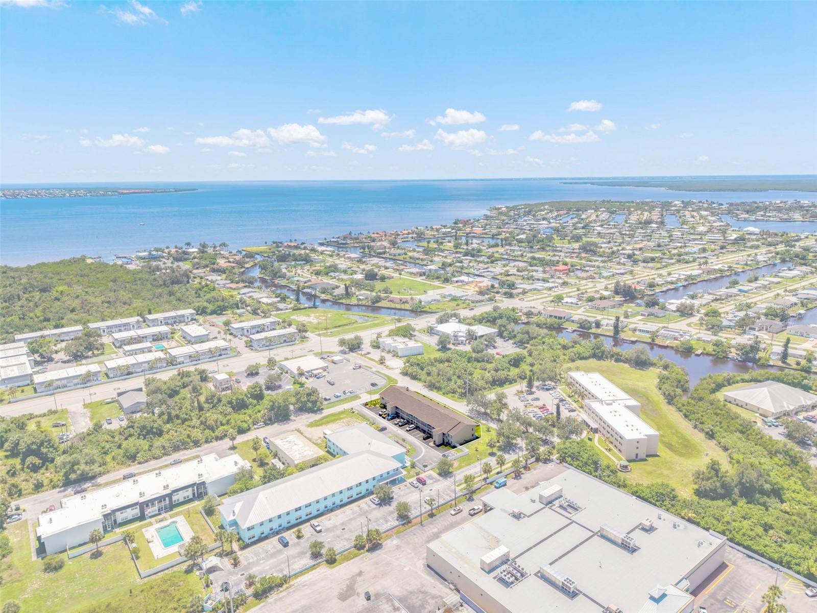 Virtually Staged. ***Investor Alert*** This spacious BOTTOM FLOOR 2 bedroom, 2 bath condo with low HOA fees located in Charlotte Harbor is ready to become your new home or a smart investment opportunity. A large living room features a picture window that fills the space with bright Florida sunshine, creating an airy and welcoming atmosphere with plenty of room for entertaining. The kitchen is equipped with abundant cabinetry and counter space, a convenient pass thru direct to the living room, and a large 4'x6' walk-in pantry readily available and  adjacent to the formal dining room. Both bedrooms are nicely appointed offering sliding glass door access to the oversized screened in lanai, perfect for enjoying serene cross breezes. The laundry room is conveniently located off the lanai. New carpeting has been installed throughout the common areas and bedrooms, enhancing the fresh and clean feel of this lovely home. Each condo comes with a dedicated parking space and ample guest parking. Ideally located within walking distance to Publix, restaurants, shopping, PG airport, Stadium and the new Sunseekers Resort, with downtown Punta Gorda just minutes away for even more walkable dining, markets, craft fairs, and waterfront iconic Fisherman’s Village and all its fabulous activities. Bring your creativity to make this one uniquely your own seasonal, year round or investment today! Welcome home to comfort, convenience, and a future vibrant Florida lifestyle!
