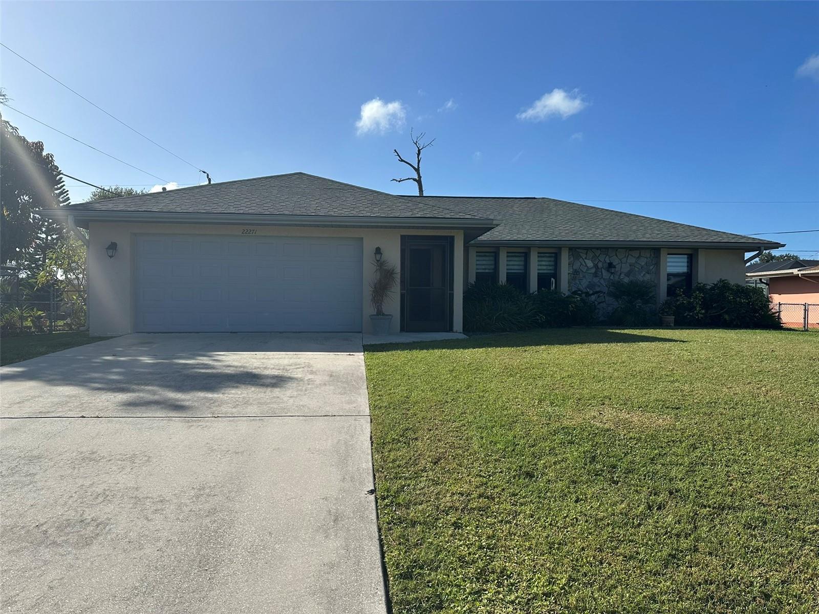 Enjoy relaxed, private living in this beautifully maintained 3-bedroom, 2-bath home featuring an updated kitchen with custom-built, solid wood 42-inch cabinets, granite countertops, and a tile backsplash. Tile flooring runs throughout the home including the bedrooms, while vaulted ceilings and sliding pocket doors create a bright, open feel and lead to a spacious screened lanai with a tongue-and-groove wood ceiling and high-end fans. Zebra shades on all windows add a polished finishing touch.

The split-bedroom layout offers comfort and privacy, with closet organizers in the 2 secondary bedrooms, and an oversized garage provides practical storage. Outdoors, unwind in the fully fenced, secluded yard, professionally landscaped in both the front and back. The home comes equipped with a new roof and 10x12 shed offering extra storage while the spectacular covered pergola—draped in Blue Sky vine—creates a distinctive setting for outdoor entertaining.

Just minutes from the shopping areas, 2 hospitals, The Port Charlotte beach complex and the new Sunseekers resort, this house is located in the New York section of Port Charlotte. It is within 10 minutes of the highway entrance and 10 minutes of the bridge which takes you to the bustling historic section of Punta Gorda where you'll find an abundance of dining and cultural opportunities.