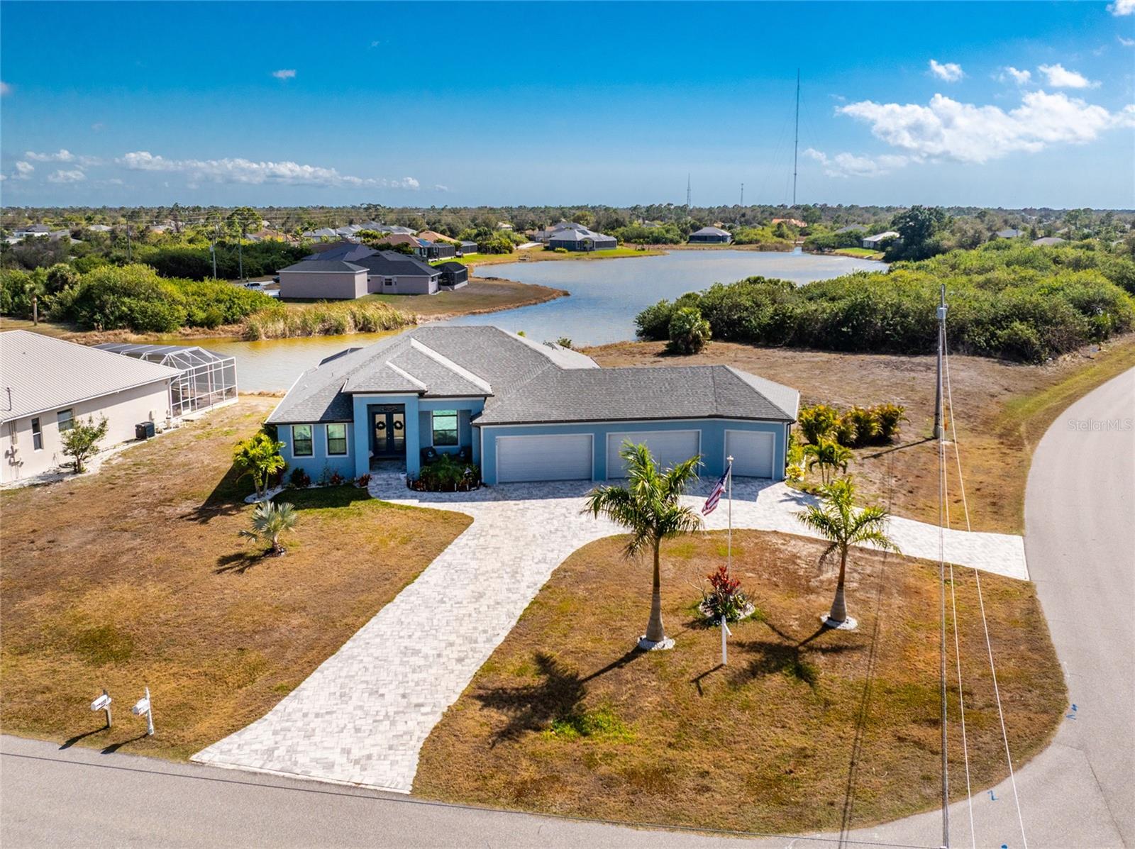 PRICE IMPROVEMENT!  MAKE YOUR MOVE! Experience the perfect blend of luxury, innovation, and effortless Florida living in this exceptional 2023 DM Dean Custom Home located in the highly sought-after Rotonda Lakes community. Perfectly situated on an oversized corner lot with tranquil lake views, this one-of-a-kind residence offers 3 bedrooms, a private office/flex room, 3 full bathrooms, a resort-style heated pool and spa, and an incredibly rare 5-car garage—a combination that's nearly impossible to find. Built by one of the area's most respected custom builders, every detail was thoughtfully designed to deliver exceptional craftsmanship, energy efficiency, and everyday comfort. From soaring ceilings with elegant coffered details to spray-foam insulation and whole-home smart technology, this nearly new home is as impressive behind the walls as it is throughout the interior. The expansive open-concept floor plan is filled with natural light and seamlessly connects the living, dining, and outdoor entertaining areas, creating the ideal setting for both everyday living and memorable gatherings. At the heart of the home is a spectacular chef's kitchen designed to impress. Featuring a massive center island with seating for six, custom all-wood cabinetry, stunning leathered granite countertops, premium induction cooktop, double wall ovens, and abundant prep and storage space, it's the perfect combination of beauty and functionality. The luxurious owner's suite is a private retreat with sliding glass doors that open directly to the pool and spa, allowing you to wake each morning to peaceful lake views. The spa-inspired ensuite bath offers a relaxing escape and even includes direct access to the laundry room for added convenience. Guests will enjoy their own private ensuite bedroom complete with a cabana bath providing direct access to the pool area—perfect for family and visitors alike. Step outside into your own private tropical oasis. Designed for year-round enjoyment, the backyard features a sparkling heated pool and spa, inviting fire pit area, expansive paver patio, and serene lake views where Florida's native wildlife creates an unforgettable backdrop. Whether you're sipping morning coffee, entertaining friends at sunset, or relaxing after a day on the water, every day feels like a vacation. One of the home's most extraordinary features is the attached 5-car garage—a true rarity. Ideal for car collectors, boating enthusiasts, hobbyists, or anyone needing exceptional storage, this incredible space also includes an attic elevator lift and partially floored attic, providing even MORE STORAGE options. Additional premium features include hurricane-impact windows and sliding glass doors, designer finishes throughout, outstanding craftsmanship, and countless thoughtful upgrades that make this home as practical as it is luxurious. Ideally located just minutes from the pristine Gulf beaches of Manasota Key and Boca Grande, you'll enjoy convenient access to world-class boating, fishing, championship golf courses, waterfront dining, shopping, parks, and endless outdoor recreation. Luxury finishes. Smart-home technology. Resort-style outdoor living. An unmatched 5-CAR GARAGE. This is more than a home—it's a lifestyle. Homes of this caliber rarely become available. Schedule your private showing today and discover one of Rotonda Lakes' most exceptional custom residences before this extraordinary opportunity is gone.