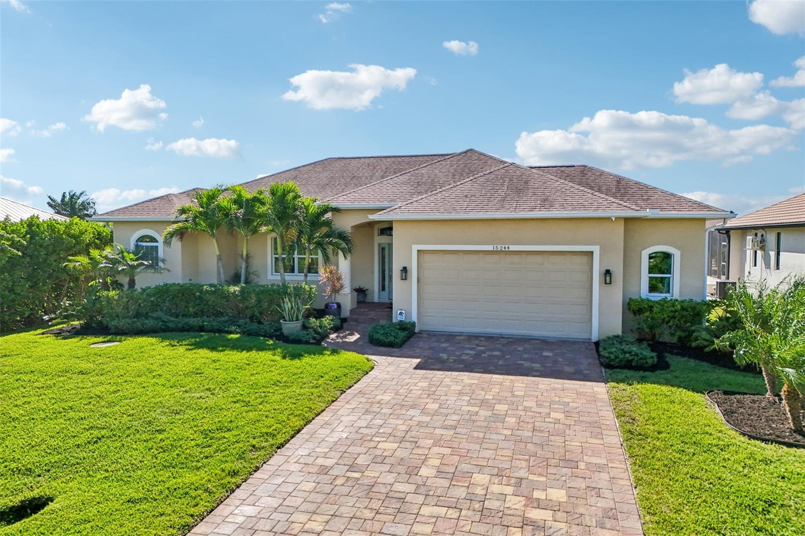 Your boater's paradise awaits!  This 3 BR, 2 BA, 2-car garage pool home is located in the heart of South Gulf Cove and offers direct boating access to the Gulf (no bridges here! sailboat access!).  Featuring a seawall, boat dock and new 13,000 lb boat lift (installed in 2025), this home will be the perfect residence for boating enthusiasts.  When you enter, you will be impressed by the thoughtfully designed split open floor plan with an abundance of natural light and spectacular water views.  Your Great Room has a tray ceiling with crown molding and opens to your gourmet kitchen with contemporary white cabinetry with deep pullout soft-close drawers, granite countertops, stainless-steel appliances, under counter lighting and an inviting breakfast island, ideally situated to enjoy your morning coffee.  You will love your pool and water views from the breakfast area and the open Dining area is generously sized and ideal when family and friends come to visit.  Your Primary bedroom suite has an en-suite Primary bath with split granite-topped vanities and a luxurious walk-in shower.  The two guestrooms share a full bath that doubles as a pool bath.  A large laundry room with a utility sink and plenty of closet space (there is a built-in desk for a home office set up) and the spacious 2-car garage complete this gorgeous home.   Step onto your lanai through the sliding glass doors to enjoy your outdoor oasis, complete with a sparkling heated pool and a newly installed summer kitchen.  In short, an entertainer's dream!  Boaters will appreciate the private dock with electricity and the 2025 installed 13,000 lb boat lift.  A canal-fed irrigation system keeps the landscaping lush and beautiful.  Home is wired for generator.  High efficiency HVAC: 2026, Water Heater: 2026, Pool Heater: 2025.  Freshly sealed pavers (lanai & driveway). South Gulf Cove is a highly desirable waterfront community, offering over 55 miles of navigable canals, boat ramp, parks and easy access to shopping, dining, golf courses and some of the best beaches in Florida.  Schedule your showing today!