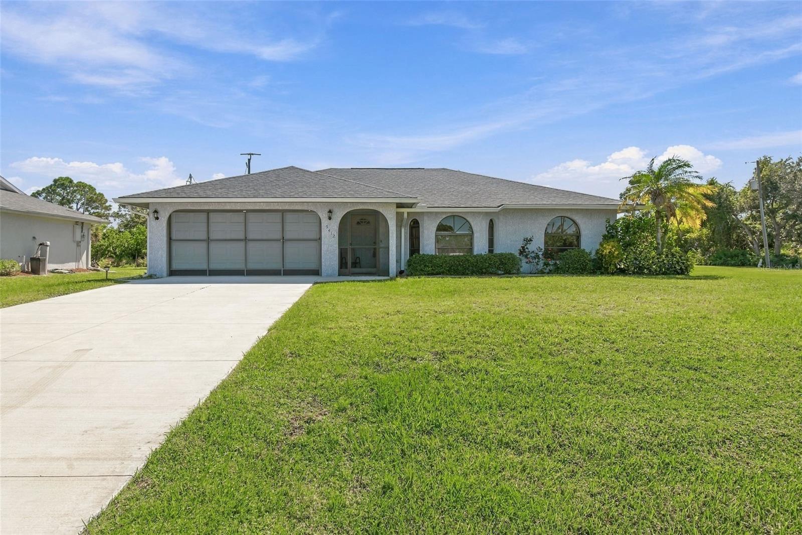 Welcome home to 5412 Gulfport Terrace, an immaculately maintained 3-bedroom, 2-bathroom, 2-car garage residence situated on a beautifully manicured LOT WITH ROOM FOR A POOL. Perfectly positioned on the desirable Englewood side of Port Charlotte, this property offers an exceptional location near the Myakka River, world-class tarpon fishing & the pristine shores of Boca Grande, and the vibrant sandy beaches of Manasota Key. Enjoy effortless access to historic Dearborn Street, 7 LOCAL PUBLIC GOLF COURSES, scenic nature trails, parks, everyday shopping, and popular dining spots. From the moment you arrive, the magnificent curb appeal stands out, highlighted by a NEW DRIVEWAY (2025), a sparkling EXTERIOR PAINTED IN 2023, and a NEW HURRICANE IMPACT GARAGE DOOR AND OPENER (2022) and a SLIDING SCREEN DOOR as well!
Inside, the thoughtful SPLIT-BEDROOM FLOOR PLAN provides wonderful privacy for family and visitors alike, enhanced by FRESH INTERIOR PAINT (2022) and NEW CARPET IN ALL BEDROOMS. The spacious MASTER SUITE serves as a peaceful retreat, featuring a private EN-SUITE BATHROOM and a generous WALK-IN CLOSET. On the opposite side of the home, you will find two charming, sunlight-filled GUEST BEDROOMS that offer cozy comfort for family or out-of-town guests, paired with a  SHARED GUEST BATHROOM designed for ease and convenience. At the heart of the home, daily living is supported by major high-value upgrades, including a NEW ROOF (2022), NEW HVAC SYSTEM (2024), NEW WATER HEATER (2022), and a NEW GARBAGE DISPOSAL (2025). The dedicated INSIDE LAUNDRY ROOM comes fully equipped with a washer and dryer, utility sink, and ample cabinet storage. Extending your living space outdoors is an EXPANSIVE, EXTENDED LANAI—freshly REPAINTED IN 2025—that is fully ENCLOSED WITH VINYL WINDOWS, offering versatile space that could easily be converted into an additional bedroom or extra family room while still leaving a wonderfully large covered lanai for outdoor relaxation. With the screened front enclosure and doors open to the back lanai you will enjoy a beautiful crossbreeze on those crisp Fall Florida Days! Combining comfort & ultimate peace of mind with an unbeatable location, this move-in-ready sanctuary is ready to welcome you to the quintessential Florida lifestyle.