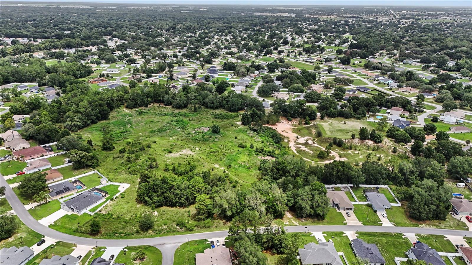 Blending rolling pastures, historic charm, and a laid-back lifestyle, this approximately 18.15-acres sits at the heart of the “Horse Capital of the World”, also known as Ocala. While this parcel enjoys a quieter feel, a short drive connects you with modern conveniences and world-class venues and training facilities, including the World Equestrian Center. This major venue offers upscale dining, shopping, events, and competitions to the broader Ocala area. Access to outdoor recreation is another major draw, with Silver Springs State Park, the Ocala National Forest, and Rainbow Springs offering hiking, paddling, wildlife viewing, and glass-bottom boat tours. Numerous trailheads are easily accessible as well, providing impeccable access to the great outdoors. In addition, Historic Downtown Ocala has restaurants, shops, festivals, and a walkable square that serves as a local social hub. Beyond the recreation activities, the parcel benefits from practical everyday conveniences. Publix, Sprouts, Walmart, Aldi, and Sam’s Club are close by for groceries, while the many shopping plazas provide daily needs, restaurants, and shopping at your fingertips. Medical care is minutes away, ensuring reliable access to healthcare services, with the Public Library and adjacent Community Center supplying local resources. Schools in the area include Elementary, Liberty Middle School, and West Port High School, all within reasonable proximity. This combination of world-class racing infrastructure and solid local amenities creates a tranquil yet lively environment ready for a builder to bring their vision to life. Schedule your private tour today and explore the possibilities in one of Florida's most established regions.