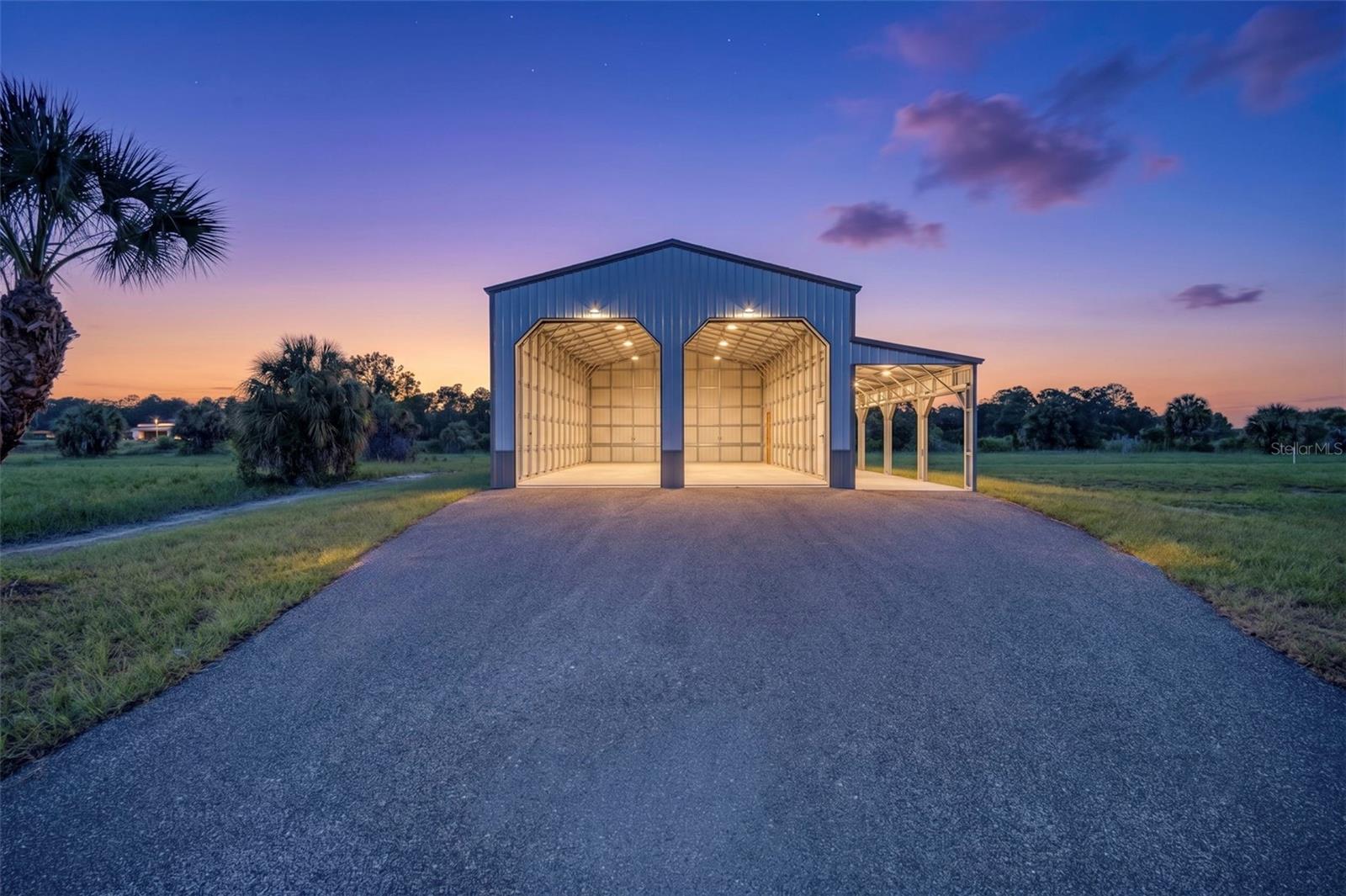 Where luxury meets functionality. Situated on 2.5 acres of AG-zoned land, this newly constructed custom barndominium-style shop offers an exceptional opportunity for ANYONE - aviation enthusiasts, business owners, collectors, AG operators -seeking a premium workshop with room to grow. Located just minutes from Punta Gorda Airport (PGD), the property features an impressive steel building with soaring clear-span ceilings, two (12x14) oversized roll-up doors, a large covered side bay, finished concrete floors, LED lighting, electric service, and an asphalt milling drive leading directly to the building. Whether you're storing RVs, boats, classic cars, heavy equipment, or operating your business, this property is designed with flexibility in mind. The 2.5-acre parcel provides abundant room for future expansion, additional structures, outdoor storage, or the construction of a custom residence. AG zoning offers the freedom and versatility that are becoming increasingly difficult to find, all while remaining conveniently close to I-75, US-17, downtown Punta Gorda, shopping, dining, and Charlotte County's growing business corridor. This is far more than just a building—it's a rare opportunity to own a turnkey property that combines acreage, accessibility, and endless possibilities in one of Southwest Florida's most desirable rural locations. Whether you're an entrepreneur, hobbyist, contractor, pilot, or investor, 7023 Austrian Boulevard delivers the space, quality, and flexibility you've been searching for. Contact us for full marketing brochure and land combination options.