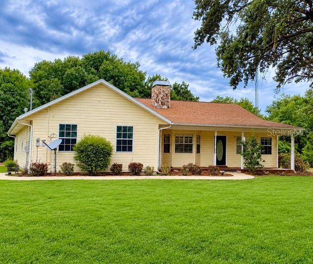 Virtually Staged. **Price IMPROVEMENT** Space, privacy, and room to make it your own! Situated on 1.73 secluded acres in Lake Placid, this well-maintained ranch-style home offers the freedom of country living with convenient access to shopping, dining, and everyday essentials. With no HOA, a detached drive-through workshop, and USDA eligibility offering the potential for 100% financing for qualified buyers, this property has plenty to offer inside and out.

The spacious split-bedroom floor plan features an open connection between the kitchen and main living areas, creating a comfortable layout for everyday living and entertaining. Updated appliances, ample cabinetry, and a breakfast nook overlooking the backyard make the kitchen a welcoming gathering place. The primary suite includes two walk-in closets, dual vanities, a walk-in shower, and private access to the lanai.

Enjoy quiet mornings or relaxed evenings on the spacious lanai, complete with a wood-burning fireplace. Beyond it, an expansive paver patio with a built-in fire pit provides even more space to entertain or unwind in your private backyard setting.

The detached workshop/garage features garage doors at both ends for convenient drive-through access and flexible space for equipment, recreational vehicles, storage, or hobbies. A chicken coop adds to the property's rural appeal, while AU zoning provides options for certain farm animals, subject to applicable county requirements.

Major maintenance and updates include a roof replaced in December 2017, A/C in 2021, a water heater in 2019, and septic service in 2025. An owned Culligan whole-home water treatment system also conveys with the property.

Located just off State Road 70 with easy access to Highway 27, this home puts daily conveniences within reach while offering a peaceful retreat surrounded by the area's lakes and outdoor recreation. Whether you're looking for room to garden, pursue hobbies, or simply enjoy more space and privacy, this Lake Placid property is ready for your next chapter. Schedule your private showing to explore everything it has to offer!