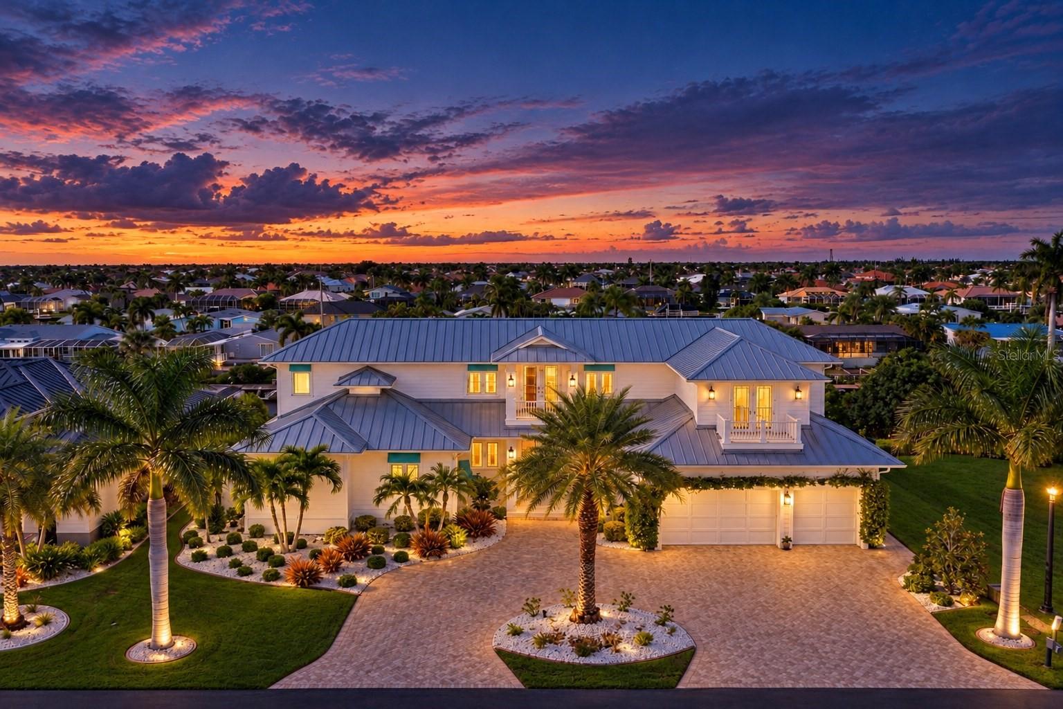 Discover exceptional waterfront living in this beautifully appointed 4 Bedroom, 4 1/2 Bath Custom Home in the intimate, Gated Community of Seamans Point. Enjoy fast, bridge free access to Charlotte Harbor and the Gulf from your private Trex dock with covered 12, 000 lb. Boat lift. A circular driveway, luxurious landscaping, and a welcoming front porch create an impressive arrival. Inside find a spacious foyer and expansive glass frame views of the water, heated custom pool with waterfall edge and spa, covered lanai with hurricane blinds, outdoor kitchen with grill, mosquito NIX misting system in the pool area and dock, and beverage refrigerator. Large windows and sliding glass doors fill the dining room and great room with natural light, while connecting the living spaces to the pool area. The kitchen and great room showcase custom woodwork. Cambria quartz countertops, tongue-and-groove ceilings, high-end GE Monogram appliances, and built-in Miele espresso machine. A large pantry and laundry room lead to an oversized three car garage, while a 20kw stand by Whole-House Generator provides added peace of mind. 2 Navien tankless gas water heater give instant hot water to the whole house for your comfort.  The opposite wing includes an office with glass French doors, a full bath with pool access, and the owner's suite. This private first floor retreat features an oversized bedroom with custom ceiling, custom separated walk-in closets with custom cabinetry, direct access lanai seating area, and a newly installed steam shower with heated bidet. Upstairs, enjoys dedicated media room with a projector, screen with ambient lighting, and movie treatment, a nearby half bath. A spacious landing opens to a second-floor balcony. One guest suite offers an en-suite bath and private porch overlooking the water, while two additional bedrooms share a well-appointed bath. Pocketing sliding doors open the main living area to the covered lanai, making indoor-outdoor entertaining effortless. The home also features 21 Sonos speakers throughout; amplification will be required. This Property offers luxury, comfort, and outstanding boating access. Schedule your private appointment today!