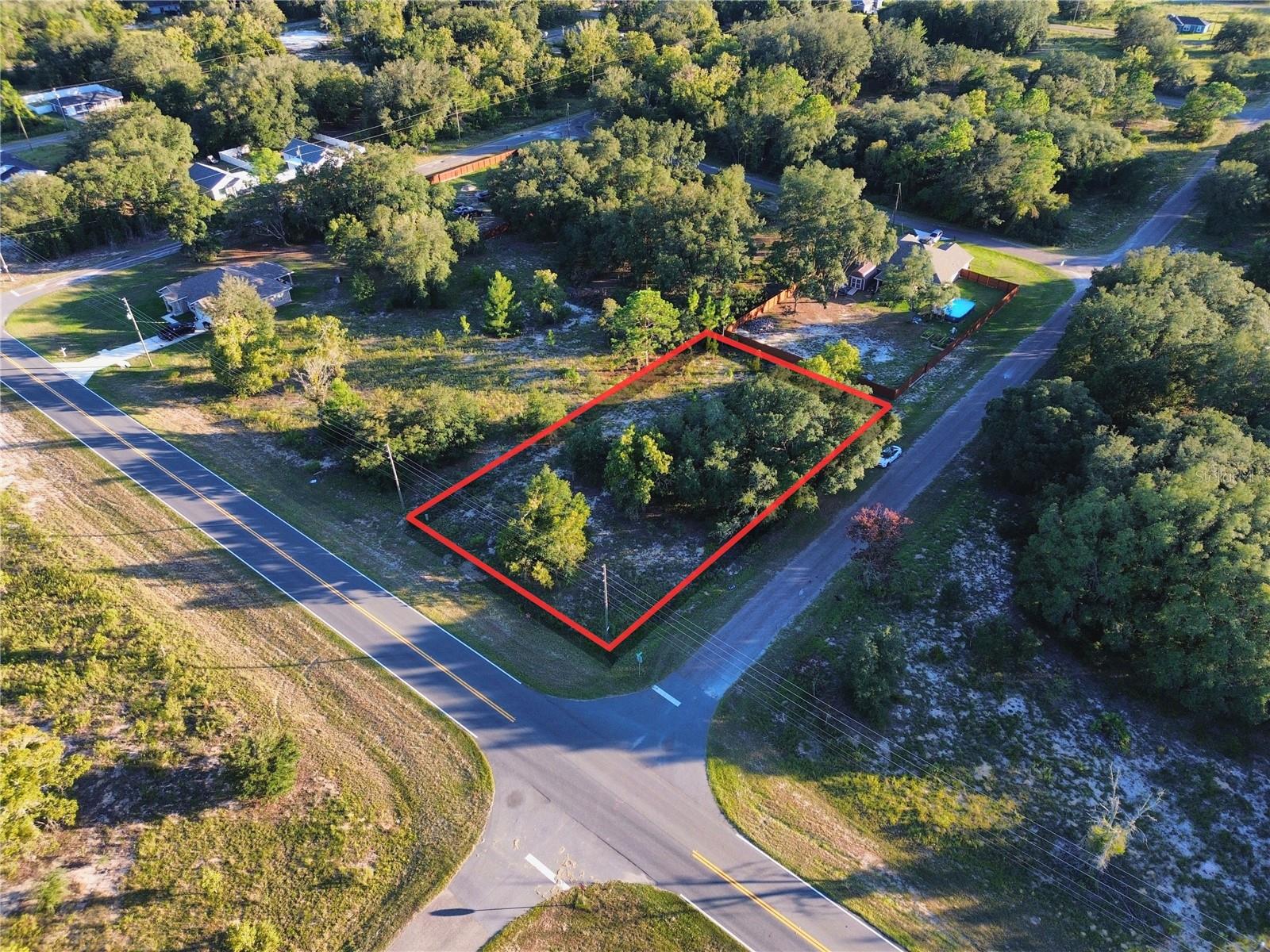 This 0.52-acre corner lot offers approximately 110' x 206' of space with paved road frontage in Silver Springs Shores, Ocklawaha. NO HOA. Zoned R-1 for single-family residential construction. The property is located in Flood Zone X, indicating minimal flood risk. Duke Energy is the area electric provider, with power lines located along the road frontage. A well and septic system will be required. Enjoy convenient access to Lake Weir, Carney Island Recreation & Conservation Area with public boat ramps, and the Ocklawaha River, offering opportunities for boating, fishing, swimming, kayaking, hiking, and other outdoor recreation. Parcel ID: 9042-1669-01. For locating the property, you may use the nearby address 14762 SE 113th Street Road, Ocklawaha, FL 32179, located approximately two lots away, or enter the following coordinates into Google Maps, Apple Maps, or Waze: 29.06029608, -81.90906951.