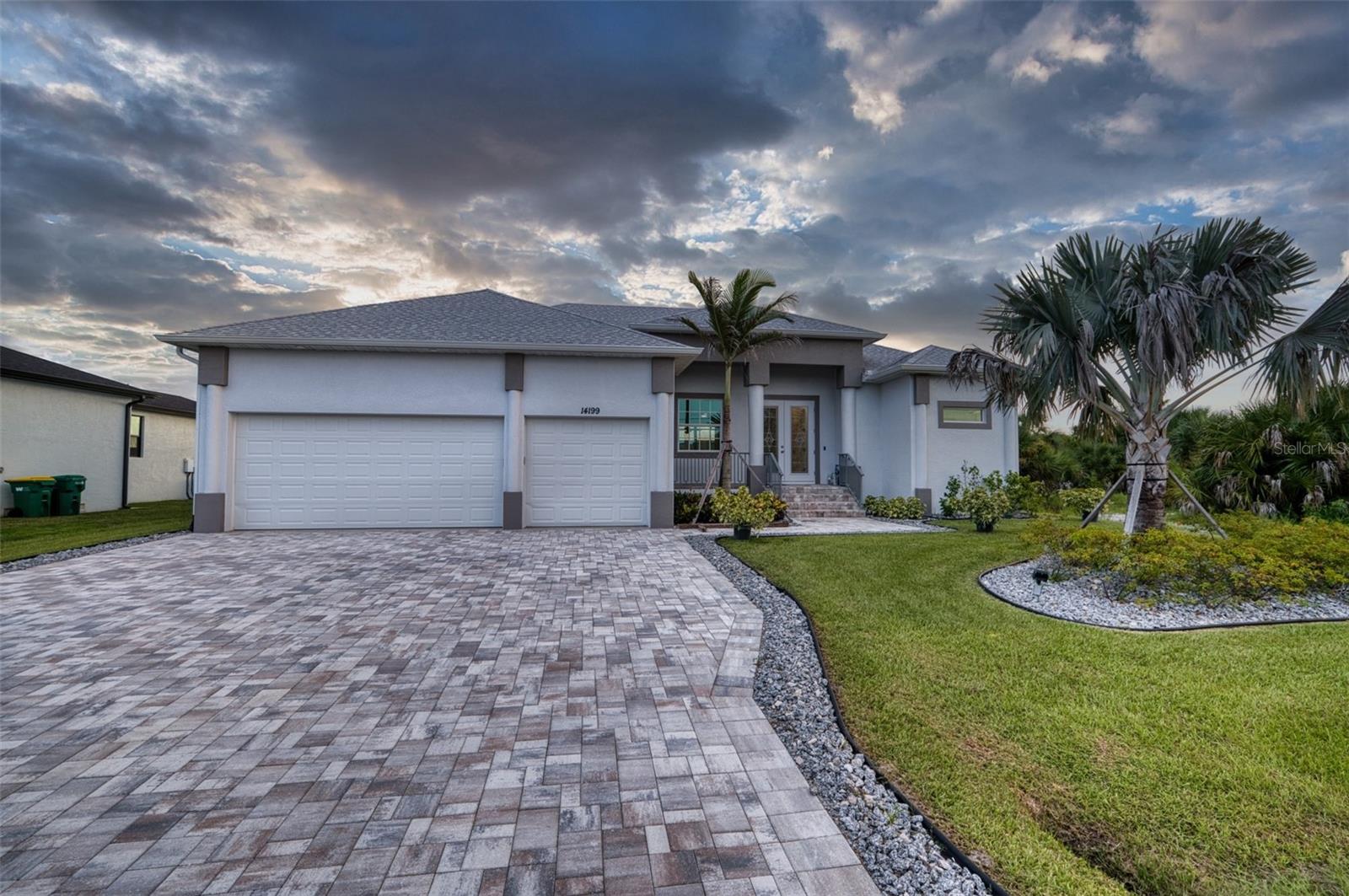 Virtually Staged. SAIL BOAT WATER with no bridges to the bay. One lock takes you straight to the Myakka River and out to the Gulf. This home is loaded with upgrades most builders skip. The front features an oversized 3 car garage with an epoxy floor, decorative railings, and a paver driveway leading to the upgraded double-door entry. Inside, the open floor plan can hav 3 or four bedrooms, with the front roomcurrently set up as a dining romm but easly converted to a bedroom or office. The primary suite has a Trayed ceiling and his-and-hers custom closets. both bathrooms feature color-changing lighted vanity mirrors. The primary's walk-in shower had triple heads and a solid concrete bench seat, built to last. The Jack and Jill bathroom includes a soaker tub with direct access to the pool area. The great room has a doubletray ceiling with color-changing rope lighting and a 72-inch fan. There is a fan in every room except the dining and eat in area of the kitchen. The kitchen is outfitted entirely with Kitchenade appliances, including a  range hood, under counter top microwave, and a double trash pullout for garbage and recycling. There's also an oversized pantry and a breakfast nook with sink-facing seating. Countertoops throughout are granite, and all the flooring is a 4.0 hardness-rated porcelain tile. Outside, the paver lanai surrounds the pebble crete pool and heated spa, with a paver walkway down the the cement seawall and dock.Pilings are in place for your boat, with electric and water hookups dockside. Impact-resistant windows and sliders run througout. The propane system powers the pool heater, stove,dryer and the Insti-hot water heater. The A/C system is a high end install. The landscape system features a BISMARK PALM and is fully landscaped with other palms and plants. The entire yard has an irrigation system. You can't build this house for what we are asking for it. All you need to do is call me and the builder will show you the house. If you have any questions he can answer them. You also will receive a one year home warranty for free! Thanks for taking your time to read this. Please check out the photos and virtural tour.
