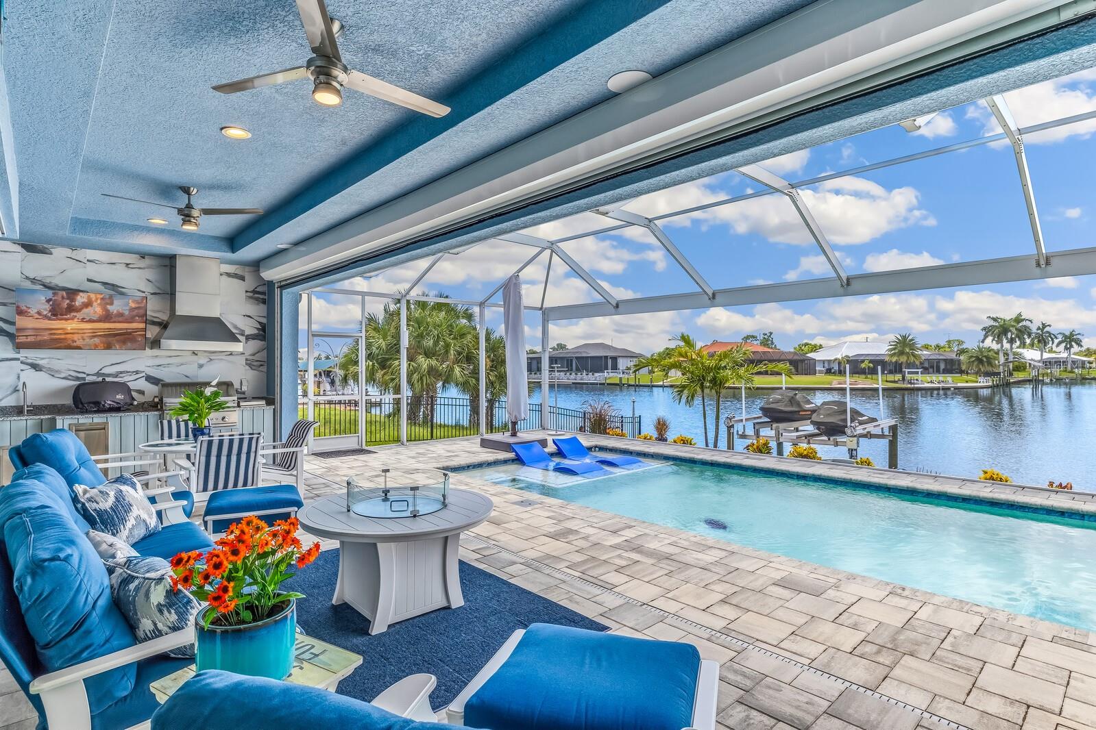 Expansive south-facing water views set the tone for this exceptional 2023 waterfront home, ideally positioned on a tee canal in South Gulf Cove. The setting feels unusually open and private, with broad water views from the main living areas, pool and lanai. **For those seeking even greater privacy, the two adjacent lots are also available for separate purchase.**

Inside, the 2,265-square-foot, three-bedroom, three-bath home is beautifully finished and impeccably maintained, with a light-filled open floor plan and thoughtful details throughout. The same attention to quality extends beyond the living spaces, from the custom outdoor kitchen to the finished, climate-controlled garage.

The waterfront has been designed for serious enjoyment of the Florida boating lifestyle. A 10,000-pound boat lift is complemented by a separate dock with dual Jet Ski lifts and an upgraded epoxy-coated concrete dock. The home's location also provides convenient access to the lock and onward to Charlotte Harbor and the Gulf.

Outdoor living takes full advantage of the setting, with a heated pool, panoramic picture-window screen enclosure, custom outdoor kitchen, landscape and pool lighting, and generous covered space for dining and entertaining overlooking the water.

Behind the finishes is an equally thoughtful collection of practical upgrades, including hurricane protection, generator wiring, spray foam insulation, zoned HVAC, smart-home and security wiring, a mosquito misting system, and a climate-controlled garage.

Nearly new, meticulously maintained and remarkably complete, this is a waterfront home where the details have already been considered, allowing the next owner to simply arrive and enjoy South Gulf Cove living at its best.