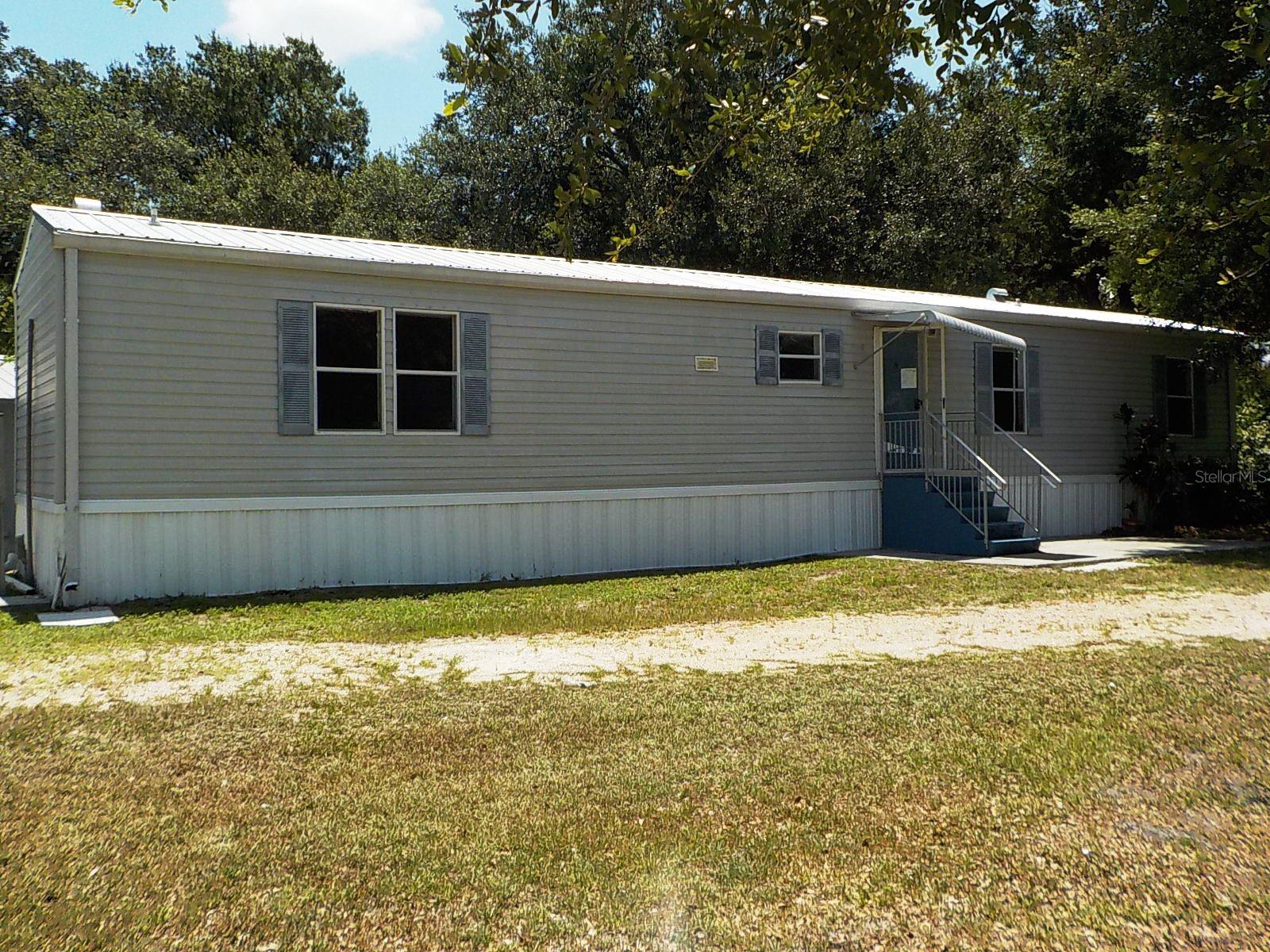 2-bedroom, 2-bath manufactured home located in the Welles Park subdivision. Built in 2004, this home offers a solid opportunity for renovation, improvement, and personalization. With a bit of updating, this home offers the opportunity to restore its original charm and make it your own.
In addition to the main home, the property features a detached outbuilding with a sink and bathroom. Seller makes no representation regarding permitted use, conforming status, occupancy approval, zoning, code compliance, square footage, utilities, or any allowable use of this structure. The buyer and the buyer’s agent must independently verify all information with the appropriate authorities. All information is deemed reliable but not guaranteed. This is a HUD-owned property and is being sold as is. FHA Case # 093-621927 IN (Insured) 203K  Eligible, subject to an FHA appraisal. FHA $100 Down Eligible. Sold AS IS. See docs for disclosure. Information is not guaranteed. Equal Housing Opportunity. The buyer pays all transfer fees, doc stamps, and title insurance. The buyer is responsible for utilities during inspections.