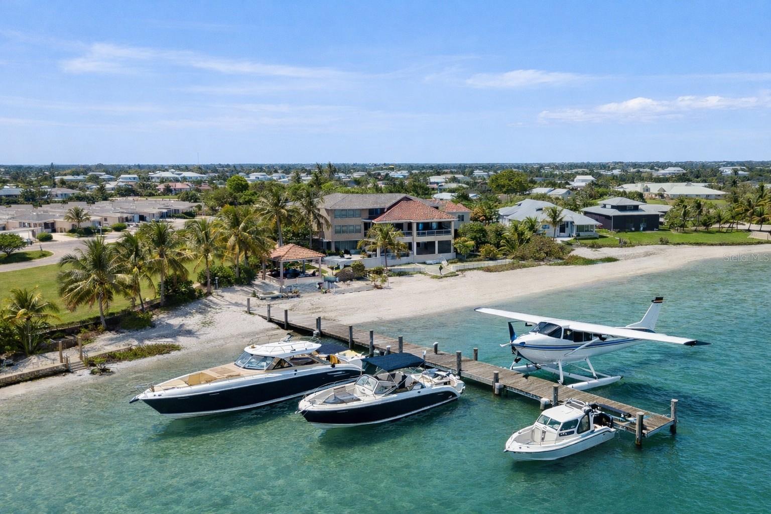 Not everyone can get here… and that’s exactly the point. Indiana Jones Adventure Meets Luxury Island Living | Rare Fly-In / Boat-In Captiva Estate. Set along the waters 300 feet of private white sandy beach & Gulf of America, this extraordinary Upper Captiva property offers one of the most unique lifestyles in Southwest Florida. Located on approximately 1.16 acres, this private island retreat is accessible by boat or private aircraft via Salty Approach Airstrip (FL90), Upper Captiva’s private 1,800-foot grass runway. The property also includes a hangar below the home, making it ideal for aviation enthusiasts. FL90 is best suited for experienced pilots flying light aircraft designed for short-field and turf operations, including planes in the style of Cessna 150, 152, 172, 182, 206, Piper Cub, Super Cub, Aviat Husky, Maule, Kitfox, and similar STOL-capable aircraft. For seaplane owners, welcome home. The residence features 5 bedrooms, 5 bathrooms, and over 3,900 square feet designed to capture panoramic water views and sunsets. A private elevator services all four levels. Inside, the home offers spacious living and entertaining areas with marble, tile, and wood flooring throughout. The chef’s kitchen includes premium appliances, wine and beverage refrigeration, ice maker, and an open layout ideal for hosting. Outdoor living is exceptional, with expansive terraces and gathering spaces overlooking the water. A new Trex waterfront deck leads to a private composite dock with boat lift, ideal for a 40-foot Viking for serious fishing adventures, plus a fast boat such as a Nortech or Midnight Express for island-hopping and cruising. The dock may also accommodate a seaplane. Additional features include whole-house generator, hurricane impact windows and doors with shutters, outdoor kitchen, poolside cabana, exercise room, multiple entertaining spaces, and well water, septic, and propane gas service. A rare combination of privacy, adventure, and luxury waterfront living in one of Southwest Florida’s most exclusive island communities.  Created for those who crave privacy, adventure, and a true sense of escape, this estate offers a lifestyle few properties can match. Spend your mornings heading out by Viking for serious fishing, your afternoons cruising by fast boat to nearby islands, and your evenings enjoying panoramic sunsets over Pine Island Sound. With a hangar below the home, private dockage, expansive terraces, and resort-style outdoor living, every detail supports an effortless fly-in, boat-in island lifestyle. This is more than a residence. It is a gateway to one of the most extraordinary waterfront experiences in Southwest Florida. With exceptional access to Boca Grande’s renowned deep-water fishing right from your back door, this remarkable estate is designed for the buyer who expects the extraordinary. Complete with a private sauna and every luxury appointment. The 29'5" x 36'7" hangar-style garage offers substantial space for aircraft.