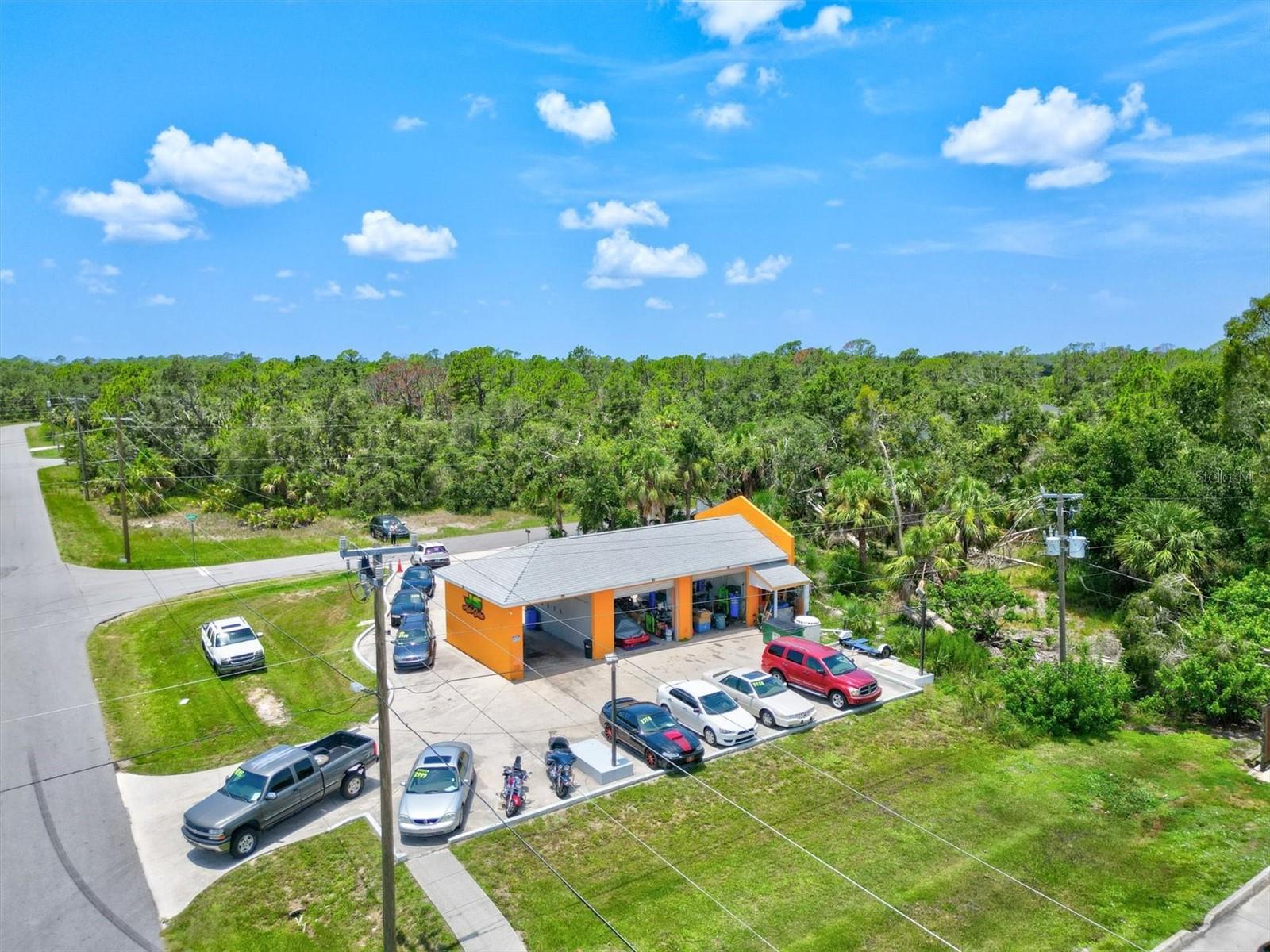 PRICE TO SELL! Commercial property zoned CG with Total 10,000 SQT. FT. of parking and 1,249 SQT. FT. building area. Four phase electric and light poles. New roof and totally remodeled.  3 Bays and an Office...#1. Bay has a lift for Auto Repairs, #2. Auto Sales Shop and #3. Car Detailing. Variety of possibilities for business opportunities! Great traffic! Located near US 41 & Cranberry intersection of North Port & Port Charlotte.