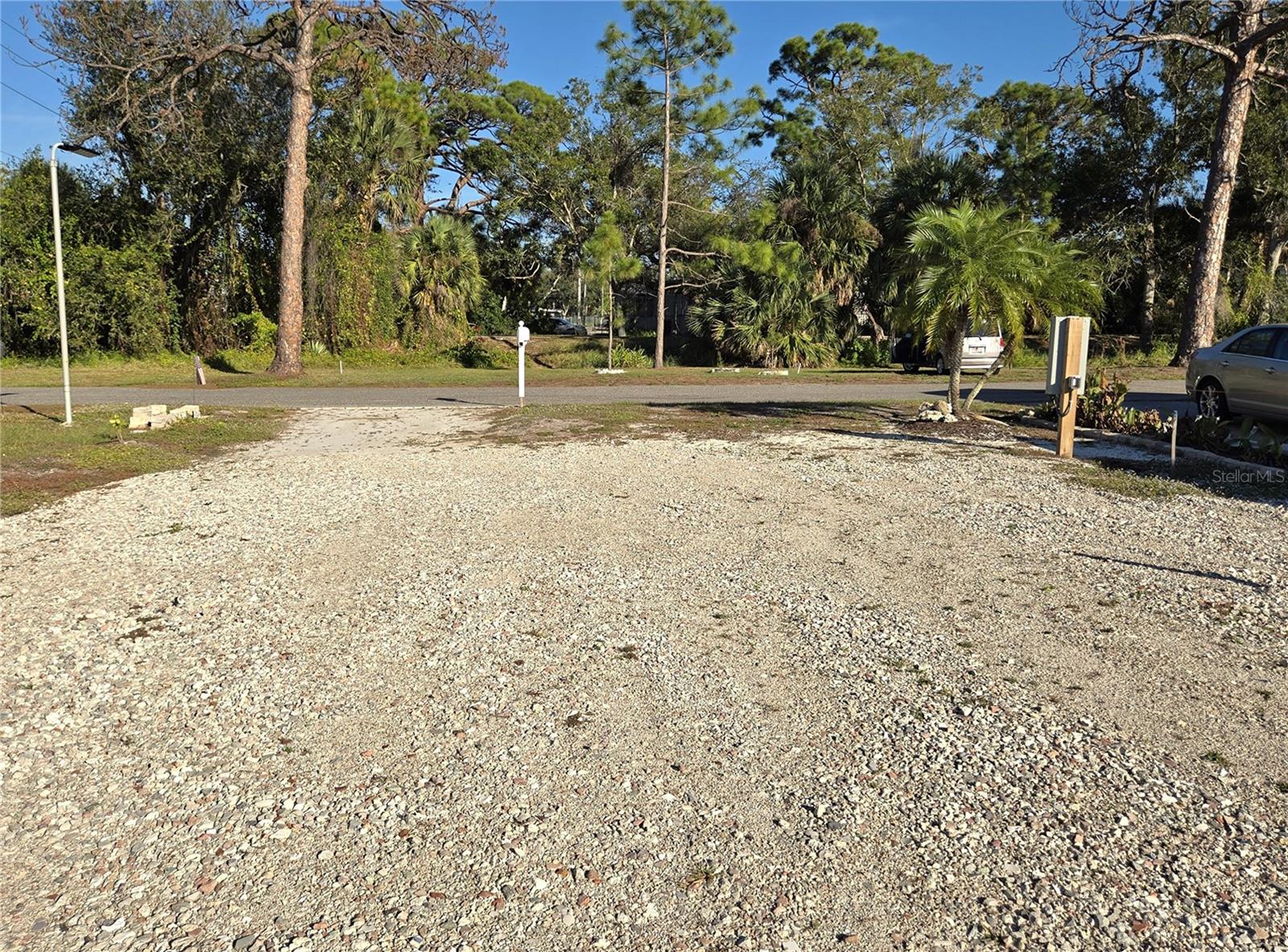 LAND. This lot is vacant, level, and cleared of old concrete, debris, and ready for your new manufactured home. The lot measures approx. 44 ft. wide x 135 ft. deep, it is one of the largest available buildable lots in the entire Venice bay area. An elevated home offers partial creek views of boats traveling, manatees, and wildlife to and from the Intracoastal Waterway.
Zoning is RMF for manufactured, elevated homes, and is part of a well-managed, pleasant 55+ community association and transitioning from old to new construction since Hurricane Milton. The low quarterly fee of $460 includes all public water & sewer usage, road maintenance, and street lighting. Additional community parking lot is available for a boat, RV, or camper.
Local amenities are endless. To the east you can hop onto the Legacy Trail or to the west walk to a marina dockside restaurant, e-bike to a beach, golf cart to Venice downtown, Sharkey's Beach restaurant, Venice beach fishing pier, a beautiful 27-hole public golf course, tennis, pickleball courts, or enjoy the symphony concerts at the Venice Performing Arts Center. 
A land survey is available from the seller. Buyer is responsible for obtaining a new building permit, electric meter from FPL, and water & sewer connections, fiber optic internet connections are all available underground utilities.