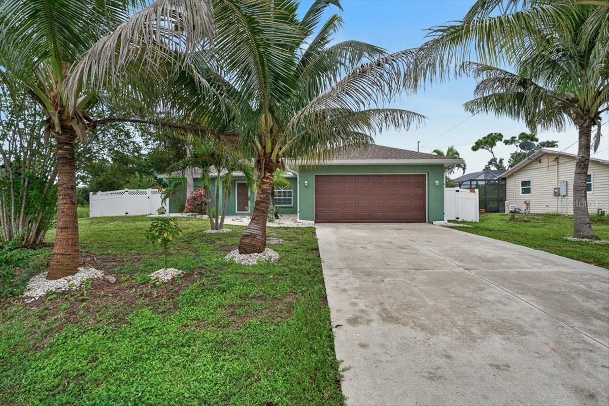Virtually Staged. Move-in ready and full of Florida charm! This inviting 3-bedroom, 2-bathroom home in Englewood offers an open-concept layout, a desirable split-bedroom floor plan, and an attached 2-car garage. Fresh interior paint and clean, fresh carpeting in all three bedrooms give the home a refreshed feel, while tile flooring throughout the main living areas keeps everyday living practical and easy. The kitchen opens to the spacious living and dining areas, creating a welcoming space for entertaining or relaxing at home.

The private primary suite features a walk-in closet and an attached bathroom with a NEW double-sink vanity and walk-in shower. Major updates include a 2023 roof, 2018 HVAC system, and 2018 water heater, offering added peace of mind. Outside, tropical landscaping and mature palm trees bring that classic Florida feel right to your doorstep.

Located in a quiet, welcoming Englewood community, you'll be close to beautiful Gulf Coast beaches, local shopping, dining, and outdoor recreation. Whether you're looking for a full-time residence, a seasonal escape, or a place to enjoy the Florida lifestyle year-round, this refreshed, move-in-ready home is ready for its next owner. Don't miss your chance to make it yours!