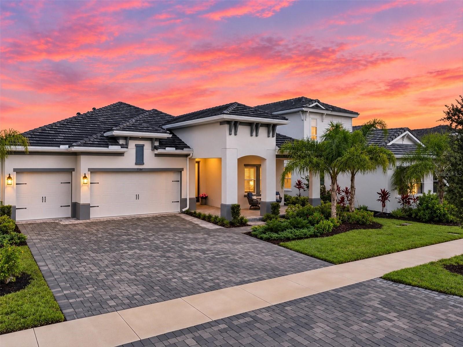 Welcome to an exceptional expression of coastal luxury in The Everly at Wellen Park, where refined design, thoughtful upgrades, and seamless indoor-outdoor living come together in this beautifully appointed West Bay home. Featuring the highly sought-after Biscayne floor plan, this residence showcases a lovely neutral coastal palette, elegant architectural details, and a private outdoor retreat designed for enjoying the Florida lifestyle in every season.
From the moment you enter, the home’s attention to detail is unmistakable. The great room takes center stage with an impressive decorative cultured stone wall, creating a stunning focal point that brings warmth, character, and sophistication to the living space. Coffered and tray ceilings, crown molding, and beautifully appointed finishes enhance the home’s elevated aesthetic, while over 22 feet of glass sliders open the interior to an expansive outdoor view, creating a wonderful sense of connection between the living areas and poolside retreat.
Step outside to your own private oasis, where a gas-heated saltwater pool and spa overlook a serene conservation backdrop. The exclusive outdoor patio provides privacy for entertaining, relaxing, and enjoying beautiful Florida evenings. Integrated outdoor speakers set the mood, while the home has been thoughtfully preconfigured with plumbing, electrical, and gas connections for a future outdoor kitchen. Imagine gathering with family and friends this winter, enjoying the pool, preparing your favorite meals, and watching your team celebrate a Super Bowl victory under the Florida sky.
The kitchen is designed to be both beautiful and functional, featuring a custom layout with an oversized luxury quartz island, soft-close cabinetry and drawers, and under-cabinet lighting. It is a space that invites conversation, culinary creativity, and effortless entertaining, all while maintaining the home’s sophisticated coastal feel.
The den or office offers a touch of distinctive character with beautifully added barn doors, creating a welcoming and versatile space for working from home, reading, or simply enjoying a quiet retreat. Throughout the residence, storm-rated windows and doors provide peace of mind, complemented by split-panel Plantation Shutters that add timeless elegance and light control.
Additional thoughtful enhancements include a whole-home water filtration system, delivering an added level of comfort and convenience to everyday living.
This Biscayne at The Everly is more than a beautifully designed home. It is a thoughtfully curated lifestyle, where luxury meets privacy; outdoor entertaining meets everyday comfort, and the distinctive amenities of Wellen Park are right outside your door.  Life in The Everly extends well beyond your front door. Residents enjoy a one-of-a-kind clubhouse, a beautifully designed gym and fitness area, pickleball courts, dog park, resort-style pool and spa, and an incredible setting with amazing views. It is a place where neighbors connect, wellness becomes part of the lifestyle, and every day feels a little more like a vacation. Conveniently located in the heart of Wellen Park and just a golf cart ride to downtown Wellen Park, near local beaches, Venice shopping and dining, Atlanta Braves Spring Training Facility, I-75, and area airports. 
Discover the beauty of coastal-inspired luxury, a private poolside retreat, and the lifestyle you’ve been waiting for in The Everly at Wellen Park.