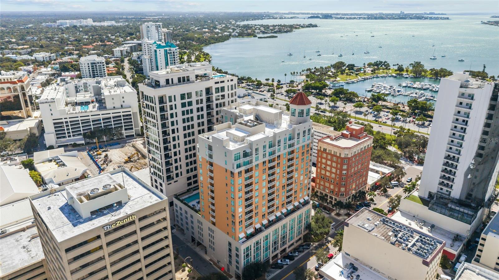 Experience the ultimate downtown Sarasota lifestyle at 1350 Main, where stylish urban living meets resort-style luxury in one of the city's most coveted locations. Perfectly positioned at the corner of Main Street and Palm Avenue, this exceptional residence puts the very best of Sarasota right outside your door. Stroll to the sparkling bayfront, explore the Saturday Farmers Market, browse boutique shops and art galleries, enjoy world-class dining, or take in Sarasota's vibrant arts and cultural scene—all just moments from home.

Perched on the 7th floor, this beautifully appointed residence offers an inviting open floor plan, warm wood flooring, elegant tray ceilings, and crown molding. Step onto your terrace to enjoy partial bay views and the energy of the downtown skyline. The beautifully updated kitchen and bathrooms feature FineCraft custom cabinetry, bringing refined craftsmanship and timeless style to the residence. The kitchen is further enhanced by granite countertops and KitchenAid stainless steel appliances. Thoughtfully designed with spacious split bedrooms, abundant closet space, and an LG smart washer and dryer, the residence effortlessly blends thoughtful design with everyday livability. The generous owner's suite is a relaxing retreat, complete with a luxurious bath featuring dual vanities, an oversized shower, and a soaking tub.

Life at 1350 Main feels like a luxury resort, with recently renovated common areas and an impressive collection of amenities, including 24-hour concierge service, a heated pool and spa, steam rooms, fitness center, resident club room, library, conference room, and guest suite. A secure parking space, climate-controlled storage, and building-wide water softening and filtration add everyday ease. Pet-friendly and ideally located just 3 miles from Lido Beach and less than 5 miles from Sarasota Bradenton International Airport, this residence places the beauty, culture, and excitement of Sarasota within easy reach.

Leave the car behind, embrace the walkable lifestyle, and discover the ease and excitement of calling downtown Sarasota home.