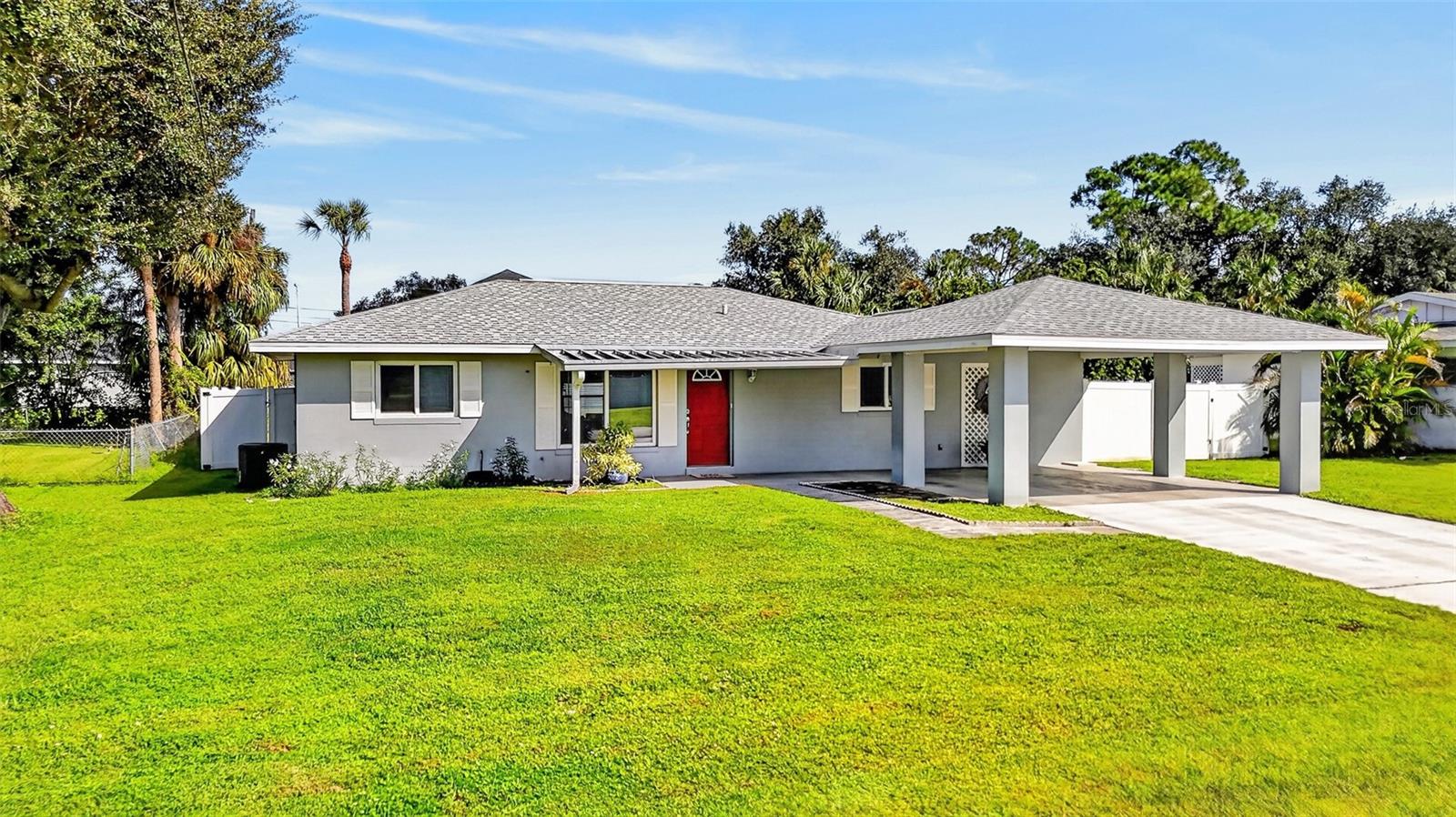 Nestled in Port Charlotte, this 3-bedroom, 2-bathroom home with a two-car carport delivers instant curb appeal with landscaping, a crisp white vinyl fence, and a welcoming red front door. Buyers will also appreciate the ultimate peace of mind that comes with a brand-new roof installed in 2022. Step inside to an inviting open living and dining space framed by sliding glass doors that look out over the lanai and pool. Adjacent, the kitchen features wood cabinetry, granite countertops, and tile backsplash. The functional primary bedroom has a ceiling fan, neutral tones, and the convenience of a private ensuite bath. Two additional guest bedrooms and a well-appointed guest bath provide comfortable accommodation for family and visitors. An enclosed Florida room adds a valuable bonus living space, making it the perfect setting for a home office, secondary lounge, or sunlit reading room. Step outside into your private Florida oasis, where a fully screened pool enclosure invites year-round swimming and outdoor entertainment. Beyond the pool cage, the spacious yard is completely enclosed by fencing and features two handy storage sheds with plenty of green space left over for pets, gardening, or outdoor fun. Conveniently located on a quiet street near US-41 and I-75, you are just minutes from the Murdock shopping and dining district, parks, golf, world-class boating, fishing, and historic downtown Punta Gorda with its arts, community events, and fine dining. Don’t miss this opportunity! Call to schedule your private showing today!