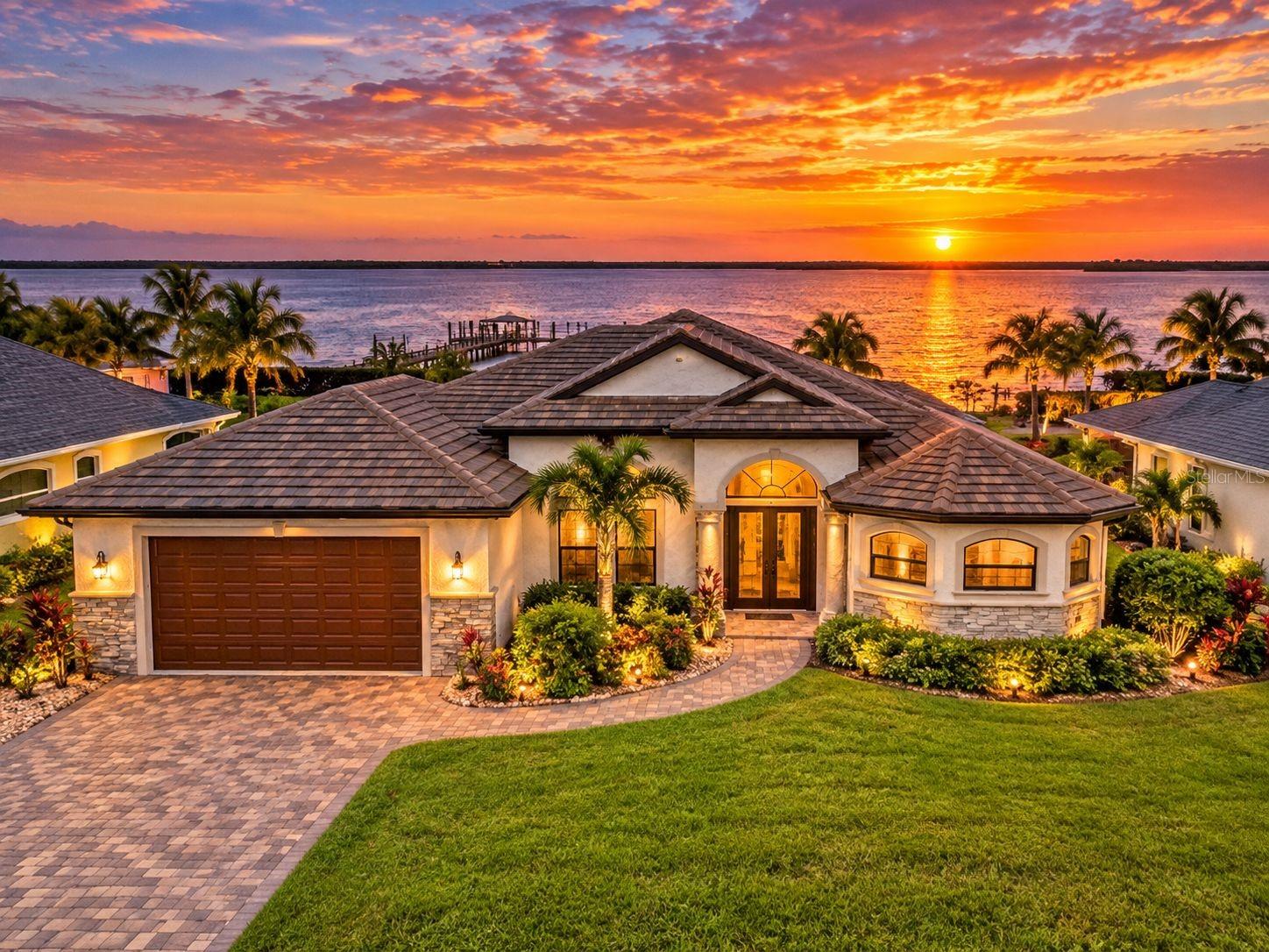 Virtually Staged. WATERFRONT LUXURY WITH A SHOWSTOPPING POOL & SPA! Discover exceptional Florida living at this beautifully appointed 3-bedroom, 2.5-bath home with den, perfectly positioned on approximately 80 feet of sailboat-access waterfront along Interceptor Lagoon with direct Gulf access. From the moment you arrive, the home's elegant details, lush landscaping, paver driveway, tile roof, impact windows and doors, and inviting screened entry set the tone for what awaits inside.

The open-concept interior features soaring coffered and tray ceilings, engineered hardwood flooring, custom built-ins, 8-foot sliders, and expansive water views. The chef's kitchen is designed for entertaining with quartz countertops, quality cabinetry, propane Viking appliances, and a convenient butler's pantry. The split-bedroom layout offers privacy, while the spacious den provides an ideal home office, media room, or flexible guest space.

OUTDOOR LIVING IS THE STAR OF THE SHOW! Step into the expansive under-truss screened lanai and enjoy your own private resort-style retreat. The heated saltwater pool features a sun shelf, spa, water feature, and striking fire wall, creating an incredible setting for relaxing, entertaining, or enjoying peaceful waterfront sunsets. The fully equipped outdoor kitchen includes a vented hood, RCS grill, mini refrigerator, quartz sink, and generous prep space. A convenient pool-access half bath and outdoor shower make entertaining effortless.

Beyond the lanai, the oversized waterfront yard leads to a composite dock equipped with water and electric, plus a 10,000-pound boat lift—perfect for embracing the boating lifestyle. With Gulf and sailboat access, breathtaking lagoon views, a spectacular pool and spa, and beautifully designed indoor and outdoor spaces, this Port Charlotte waterfront residence delivers the Florida lifestyle you've been waiting for.