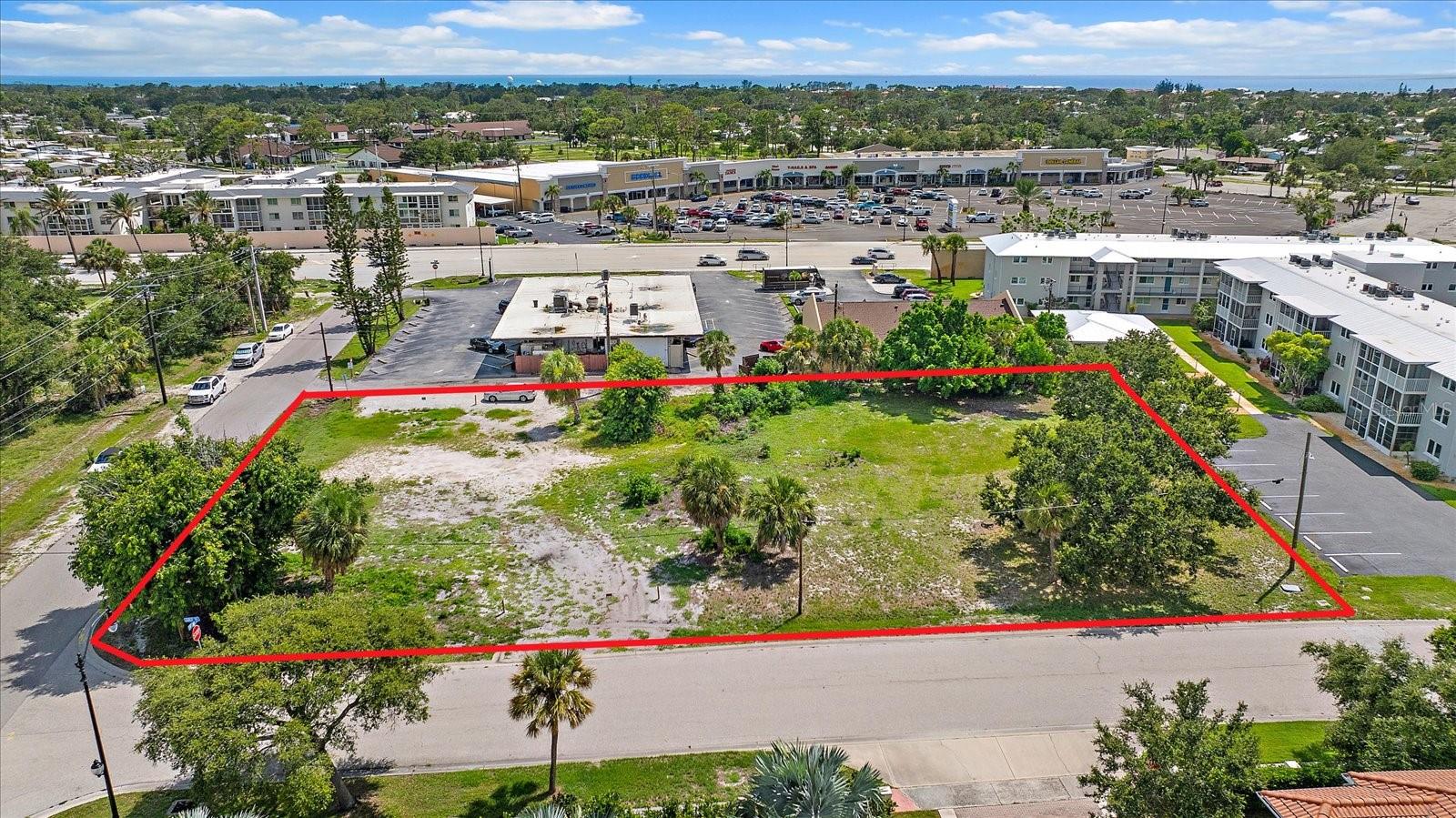 Rare opportunity to build on this 0.74-acre (±32,218 sq ft) lot on the island of Venice, Florida — just minutes from historic downtown. Zoned RMF4 for multi-family residential use, the site is entitled by right to 13 residential units, suited to townhomes, condominiums, or apartments. Additional density may be possible beyond this base entitlement: Sarasota County permits smaller “half units” under 750 sq ft each, which could potentially allow up to 26 units, though this has not yet been confirmed by the City of Venice. Density bonuses could further increase the unit count — potentially up to 52 units — subject to City of Venice confirmation and a requirement to designate some units as attainable housing; this higher figure remains unconfirmed. Conceptual renderings are available for a townhome or residential building concept. A short walk to the island’s only supermarket and tucked behind a popular local restaurant, with a short drive to the beach, this lot sits in one of Southwest Florida’s fastest-growing and most sought-after markets, with significant new development nearby. Additional conveniences include proximity to the Legacy Trail and Venetian Waterway Trail, Venice Municipal Airport, multiple public beaches, and the new state-of-the-art Sarasota Memorial Hospital. An affordable entry point for developers and investors looking to secure land in a desirable, expanding coastal community.