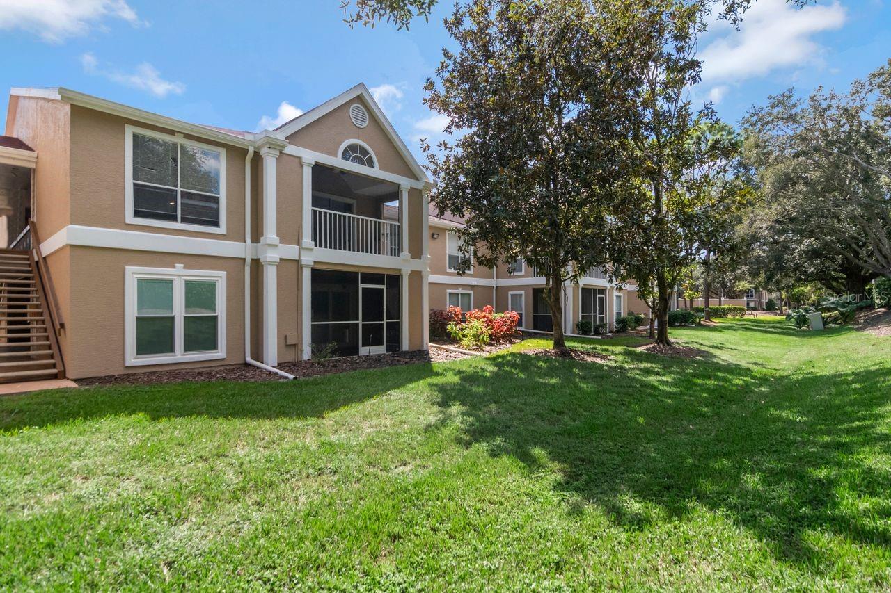 Beautifully updated and filled with natural light, this 2-bedroom, 2-bathroom condo offers comfortable living in The Highlands at Hunter’s Green, a gated community with a 24-hour staffed entrance. Located on the second floor, this inviting residence features a split-bedroom floor plan. The open kitchen blends style and functionality with granite countertops, modern cabinetry and a center island with electrical power. The flowing layout connects the kitchen to the living and dining areas, creating a welcoming setting for everyday living and entertaining. Step outside to your private screened patio with epoxy-finished flooring, the perfect spot to enjoy morning coffee or unwind at the end of the day. Tucked toward the rear of the condo, the primary suite features a large window, a walk-in closet, and an ensuite bath with a stone-floor shower and floor-to-ceiling glass enclosure. The generously sized guest bedroom offers oversized windows and ample closet space, while the guest bathroom features a walk-in shower. A spacious laundry room includes a full-size, side-by-side washer and dryer, along with a convenient folding cabinet. One assigned parking space and nearby guest parking add everyday convenience. Enjoy access to The Highlands community pool and fitness center, along with Hunter’s Green amenities, including a scenic nature trail, lakefront park, picnic pavilions, dog park, basketball courts, and tennis courts. Optional membership opportunities are available for the Hunter’s Green clubhouse and golf course. Conveniently located near shopping, dining, and I-75, this condo offers an appealing combination of thoughtful updates, community amenities, and an accessible Tampa location.
