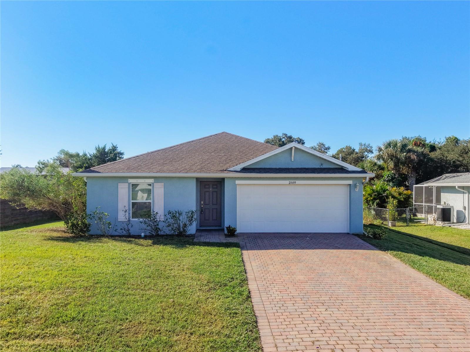 Welcome to this 5 year old home in Port Charlotte. This Freeport floor plan gives you 1,504 square feet of open living space with 4 bedrooms, 2 full baths, and a 2 car garage. Tile runs through the main living areas while the bedrooms have carpet, and the kitchen comes with stainless steel appliances including the refrigerator plus the washer and dryer, all included in the sale. The primary suite has a large walk in closet and walk in shower. Built as a concrete block structure with no HOA and sitting in Flood Zone X, it is the kind of solid, low maintenance home that has been moving in the area. Conveniently located near shopping, restaurants, and grocery stores with a short drive to I-75 for Fort Myers, Venice, and the beaches.