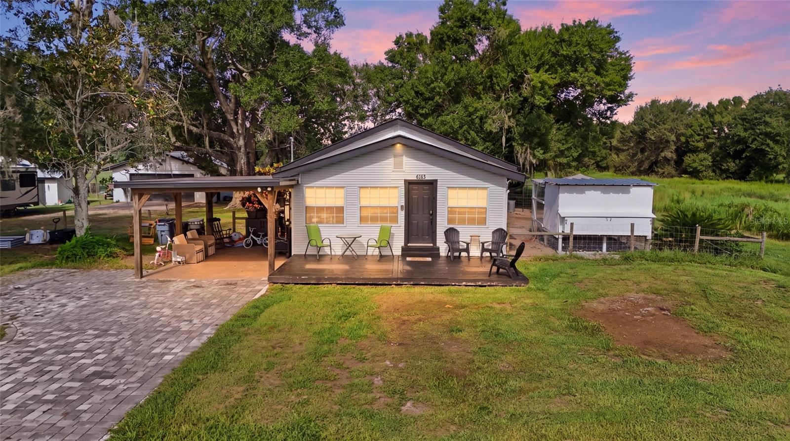 If your version of home includes a front porch, animals in the pasture, room between you and your neighbors, and a little dirt on your boots, this one deserves a look. Set on four high-and-dry agricultural acres, 5135 SW Smith Ave offers the space to actually live the country lifestyle you've been looking for. The property is divided into two separate tax parcels, with the home situated on approximately one acre and three additional fenced acres stretching behind it. Bring the horses, cows, chickens, or simply enjoy having land with possibilities. With water already available in the back pasture and power at the pole barn, much of the groundwork is already in place. Inside, the 3-bedroom, 1.5-bath home has plenty of character, including beautiful pine ceilings and built-in shelving, but the beautifully updated kitchen brings a fresh, modern feel to the heart of the home. It’s a space that feels bright, functional, and ready for everything from busy weekday mornings to big family dinners. You'll also find an indoor laundry room and thoughtful details throughout that make the home as practical as it is inviting. Outside, the property just keeps delivering. A metal roof adds peace of mind, while the detached concrete block garage with electricity gives you valuable space for a workshop, equipment, hobbies, or extra storage. The front porch is made for slow mornings and evening conversations, and the covered pavilion creates the perfect spot for outdoor dinners, cookouts, and gatherings. Beyond it all, the fenced pasture opens up behind the home and gives you the freedom to make these four acres work for the life you want to live. Whether that means animals, gardening, projects, another homesite, or simply more space and fewer neighbors, this is the kind of property that gives you options. Come see what life could look like with a little more land and a lot more room to breathe.