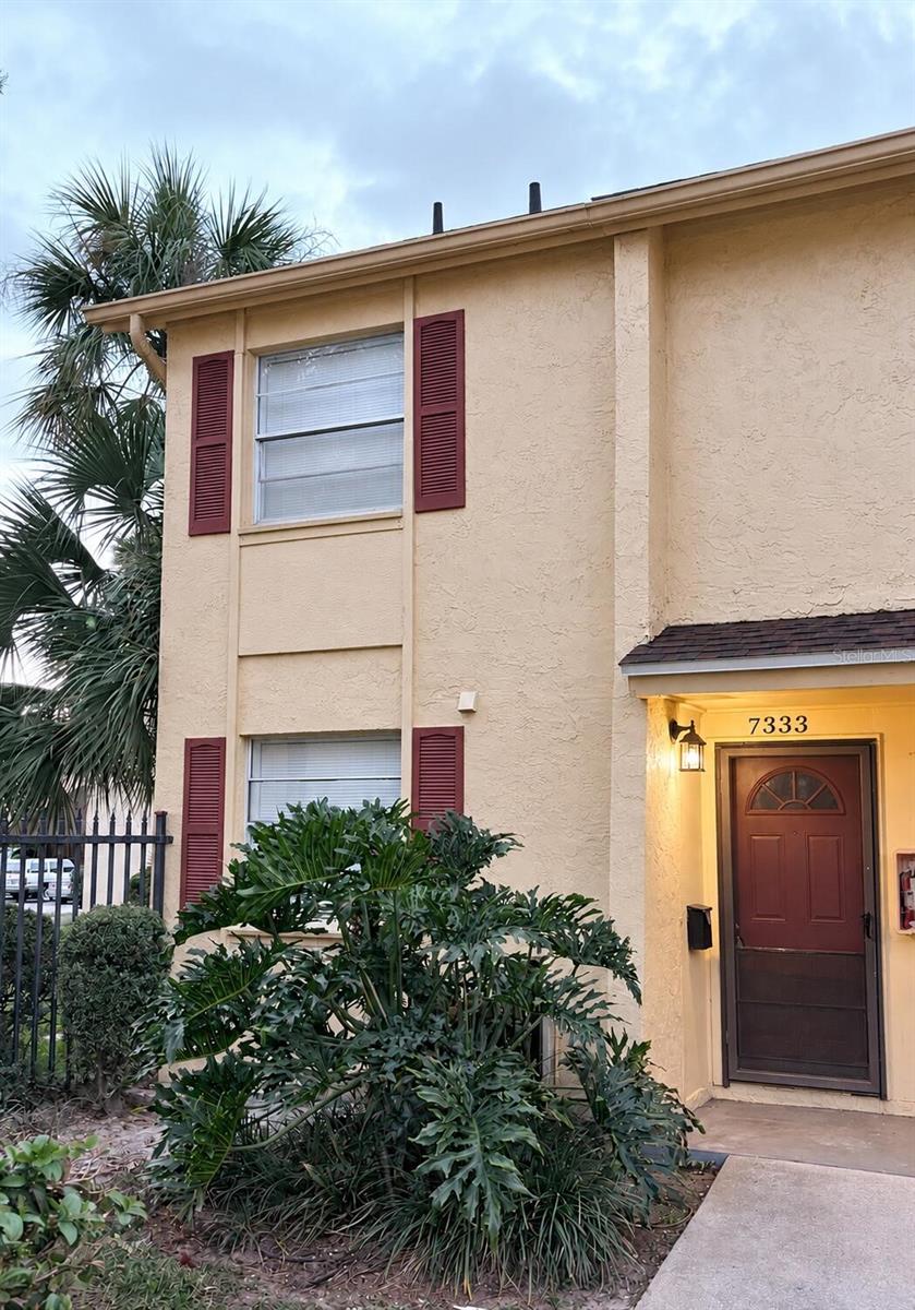 One or more photo(s) was virtually staged. Freshly renovated interiors, relaxing pool views, and a convenient Tampa location come together in this beautifully updated 2-bedroom, 1.5-bath condominium in The Greens of Town 'N Country. With 1,268 square feet across two levels, this home combines modern finishes with comfortable everyday living. The low monthly association fee of $383.51 includes water, sewer, trash collection, exterior maintenance, grounds care, community amenities, and the association's master insurance policy. Electricity is billed separately to the owner.

The newly renovated kitchen features crisp shaker-style cabinetry, quartz countertops, contrasting black hardware, and a new faucet. New luxury vinyl plank flooring flows throughout the downstairs, while brand-new carpeting upstairs and on the staircase adds warmth and comfort. Fresh interior paint, updated lighting, and new interior door hardware create a cohesive, refreshed feel.

Both bathrooms have been updated with new vanities, mirrors, faucets, and lighting. Step outside onto the freshly painted deck to enjoy views of the community pool-a welcoming setting for morning coffee or unwinding at the end of the day. Assigned parking directly outside the unit adds everyday convenience.

Community amenities include two swimming pools, tennis courts, and a fitness center. Nearby shopping, dining, Tampa International Airport, and access to the Veterans Expressway make this location convenient for enjoying Tampa and the surrounding area.

A stylish combination of updated interiors, outdoor space, and community amenities in the heart of Town 'N Country.