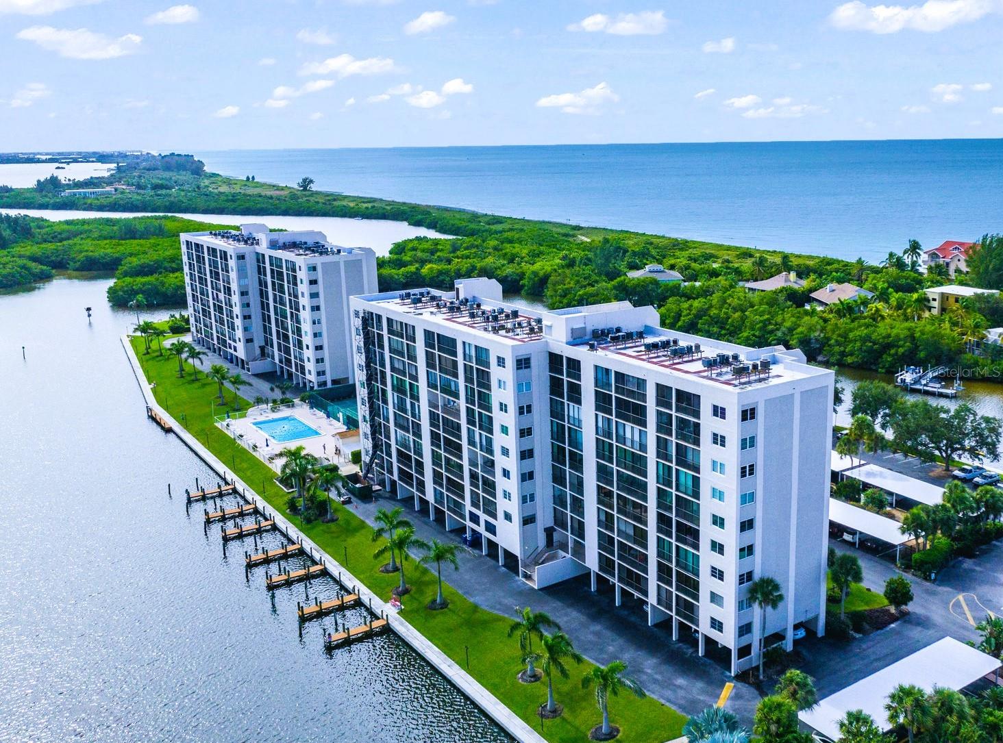 Live your dream in this light and bright 6th-floor 2-bedroom, 2-bath condo with spectacular views of both the Gulf and the Bay! This unit is the perfect place to watch a sunrise or a sunset and soak in the beauty of Neville Preserve, Little Sarasota Bay, and the Gulf! Gorgeous bay views are showcased along the back of the unit through floor-to-ceiling sliders that span the entire space. The open kitchen features quartz countertops, white cabinetry, stainless steel appliances, and full Gulf views. The large master bedroom overlooks the Bay and features abundant closet space and an en-suite bath. A second bedroom and hall bath are ideal for family and/or guests. Additional conveniences include a washer/dryer in a closeted utility area and a ground level storage unit—perfect for beach and golf gear. An assigned covered parking space is conveniently located near the building entrance. Furnished and move-in ready!.  The stack pipe replacement work for this unit has been completed and all association projects are paid for and there are no outstanding assessments. The Pointe, a unique community located at the southernmost end of Siesta Key, is surrounded by water on three sides. Just south of The Pointe, recently reopened Midnight Pass connects the Bay and Intracoastal Waterway to the Gulf - enhancing boating, estuaries, marine life, and real estate values! A gated property, The Pointe is beautifully landscaped and features every amenity: a heated pool and spa, lighted tennis and pickle ball courts, private boat docks, kayak and paddleboard racks and launch, exercise rooms, men's and women's saunas, a beautiful club house with a fireplace and a full kitchen, a private island with gazebo and grills, and on site management and maintenance. This five plus acre property is conveniently located just a few minute's walk from Turtle Beach and three restaurants. Come live at the less traveled, more tranquil end of the Key and enjoy the walking and bike paths under tree-lined Midnight Pass Road. Boat docks are available!!
