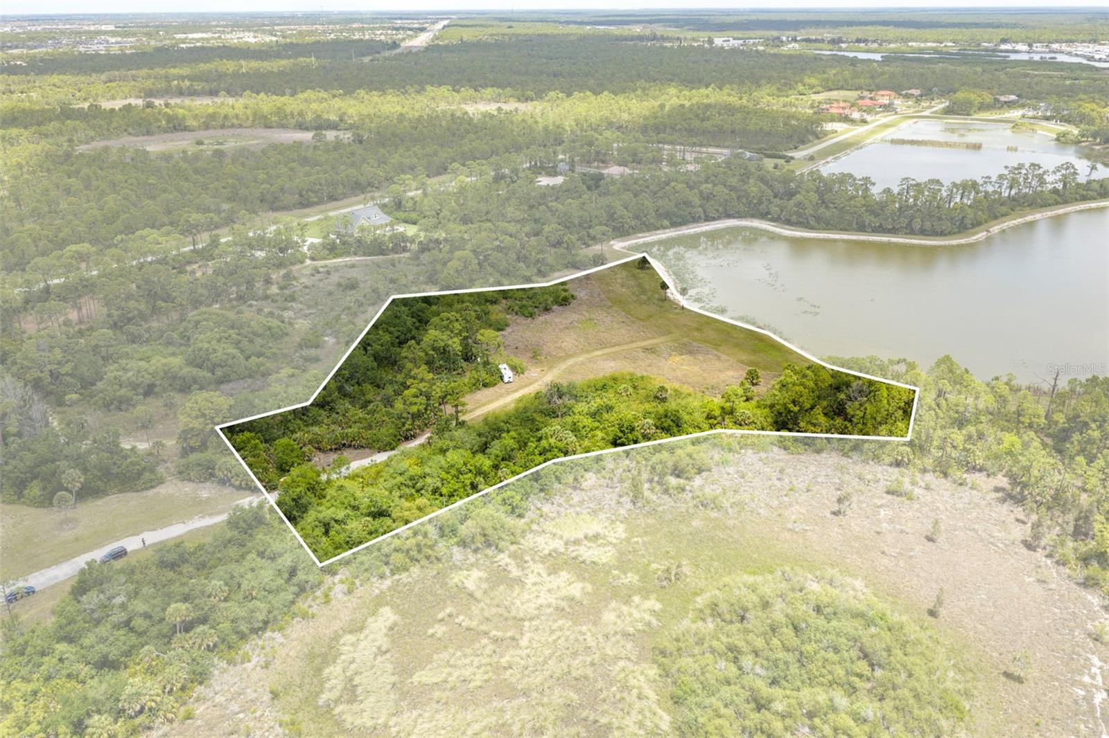 4.2+ ACRES | 500+ FEET OF LAKE FRONTAGE | UNMATCHED PRIVACY | LAKE GERALDINE

Some properties are special. This one is exceptionally rare.

Discover more than 4.2 acres of lakefront land with 500+ feet of frontage, remarkable privacy, and no neighboring homes immediately flanking either side. Tucked within the intimate equestrian community of Lake Geraldine and positioned just outside the rapidly expanding Wellen Park area, this is an extraordinary opportunity to create something truly your own in one of Southwest Florida's most dynamic growth corridors.

The property's natural wetland buffers on both sides provide an exceptional sense of seclusion, helping preserve the peaceful setting and expansive feel of this one-of-a-kind homesite. Imagine waking each morning to your own private stretch of waterfront, with room to build a substantial estate, equestrian property, family compound, or private Florida retreat.

And unlike many large parcels, this property offers a head start toward bringing that vision to life. Electricity is already on site, the property has been mostly cleared, a survey is available, and preliminary well and septic placement plans have been prepared.

The possibilities are limited only by your imagination. Design a signature lakefront residence surrounded by nature. Create an equestrian-inspired estate with room to roam. Or simply preserve the land's extraordinary privacy and build a peaceful sanctuary away from the crowds—while remaining close to the energy and growth of Wellen Park.

4.2+ acres. 500+ feet of lake frontage. Exceptional privacy. Equestrian community. Near Wellen Park.

Land with this combination of size, waterfront, privacy, and location is increasingly difficult to find. If you've been waiting for a property that gives you the space and freedom to create something extraordinary, this may be the opportunity you've been waiting for.