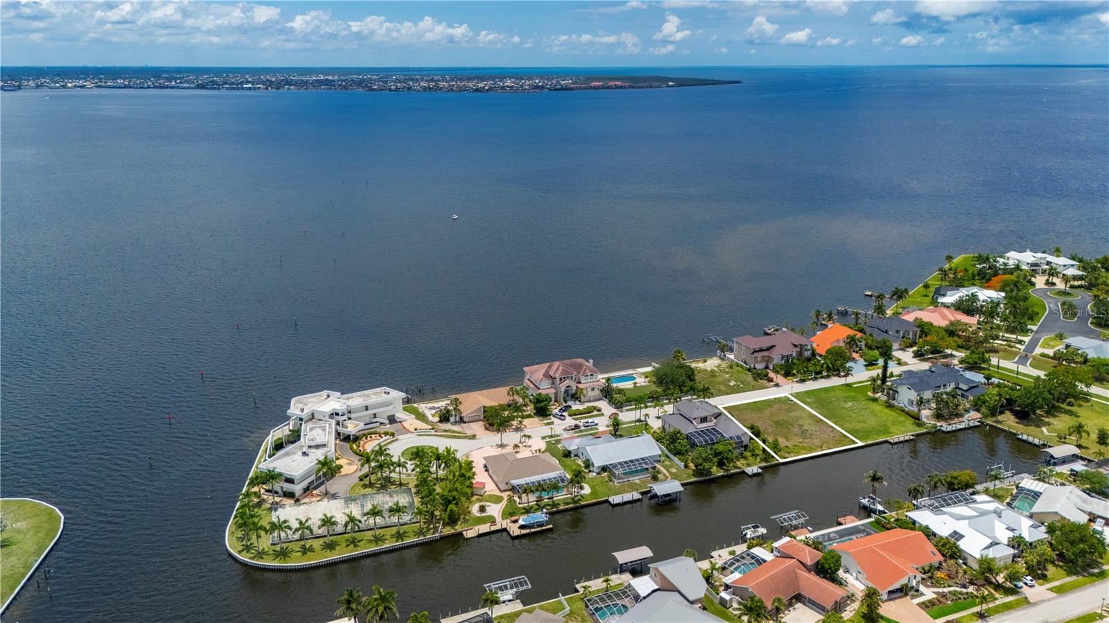Picture stepping from your backyard onto your boat and reaching open water within minutes for world-class fishing, sailing, cruising, and waterfront dining. Unique waterfront lot opportunity offering 100ft of concrete seawall and Sailboat-access water with no bridges to open water. Positioned just four lots from Charlotte Harbor, this premium homesite provides direct boating access to the Peace River and Charlotte Harbor in approximately three minutes, making it an exceptional choice for boating enthusiasts, anglers, and sailing aficionados. Cleared 100' x 125' , this build-ready property is equipped with access to public water and sewer, creating the perfect foundation for your custom waterfront estate. The expansive seawall provides ample space for a private dock and effortless access to some of Southwest Florida's most sought-after waterways. The peaceful canal setting delivers a serene coastal atmosphere while remaining conveniently close to restaurants, shopping, Punta Gorda airport, Gulf beaches and golf courses. Whether your vision includes a modern coastal masterpiece, a luxury waterfront retreat, or a timeless Florida-style residence, this exceptional sailboat-access lot offers endless possibilities. Secure your place in paradise and create the waterfront lifestyle you've always imagined!