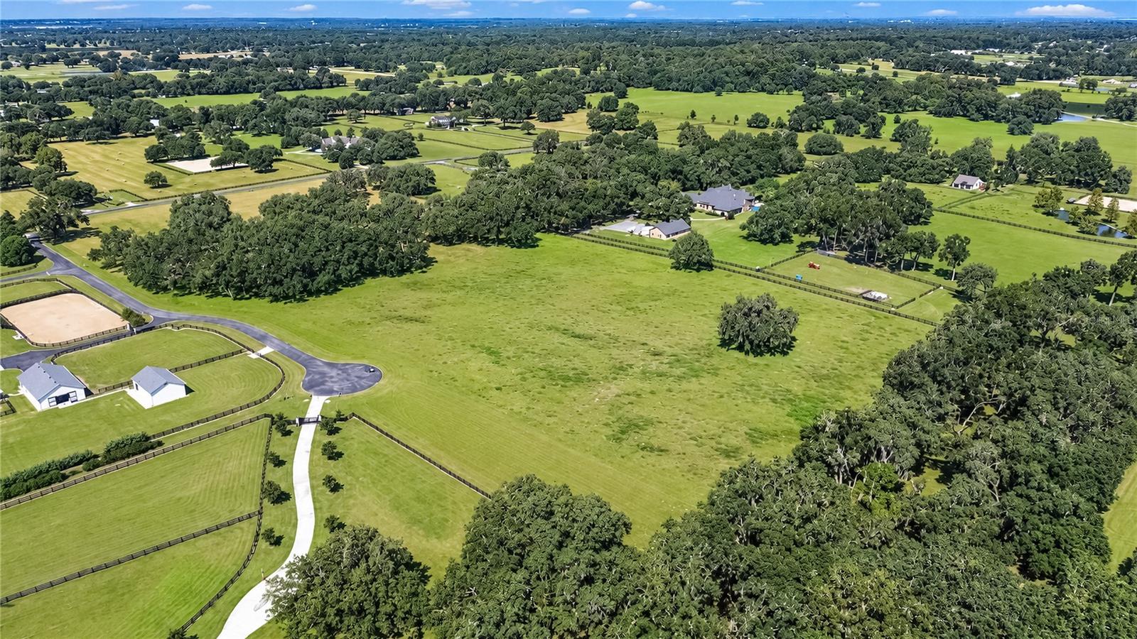 Nestled within the renowned equestrian community of Equine Estates in Southwest Ocala, this exceptional 20+ acre parcel offers a rare opportunity to create the horse farm of your dreams. Featuring magnificent 150-year-old oak trees and a beautifully cleared, park-like setting, this is truly a special piece of land.

Zoned A-1, the property offers several ideal locations for a future home or barn, with plenty of space to create paddocks, riding areas, and other equestrian amenities. Utilities within the community are underground, preserving the natural beauty and character of the area, and an HOA is in place.

Equine Estates provides excellent opportunities for both on- and off-property riding, including a bridle path around the community with direct access to the Florida Greenway and its miles of scenic trails. The Florida Horse Park is just around the corner, while the World Equestrian Center (WEC) and HITS are an easy and scenic drive away, providing year-round opportunities for competition and spectating.

Conveniently located near Ocala and The Villages, you'll also have easy access to shopping, dining, medical services, and entertainment.

If you're looking for a beautiful piece of land where you can build a custom home and create your own dream equestrian estate, this exceptional property offers the space, location, and natural beauty to make it a reality and to get the best that the Horse Capital of the World® has to offer.