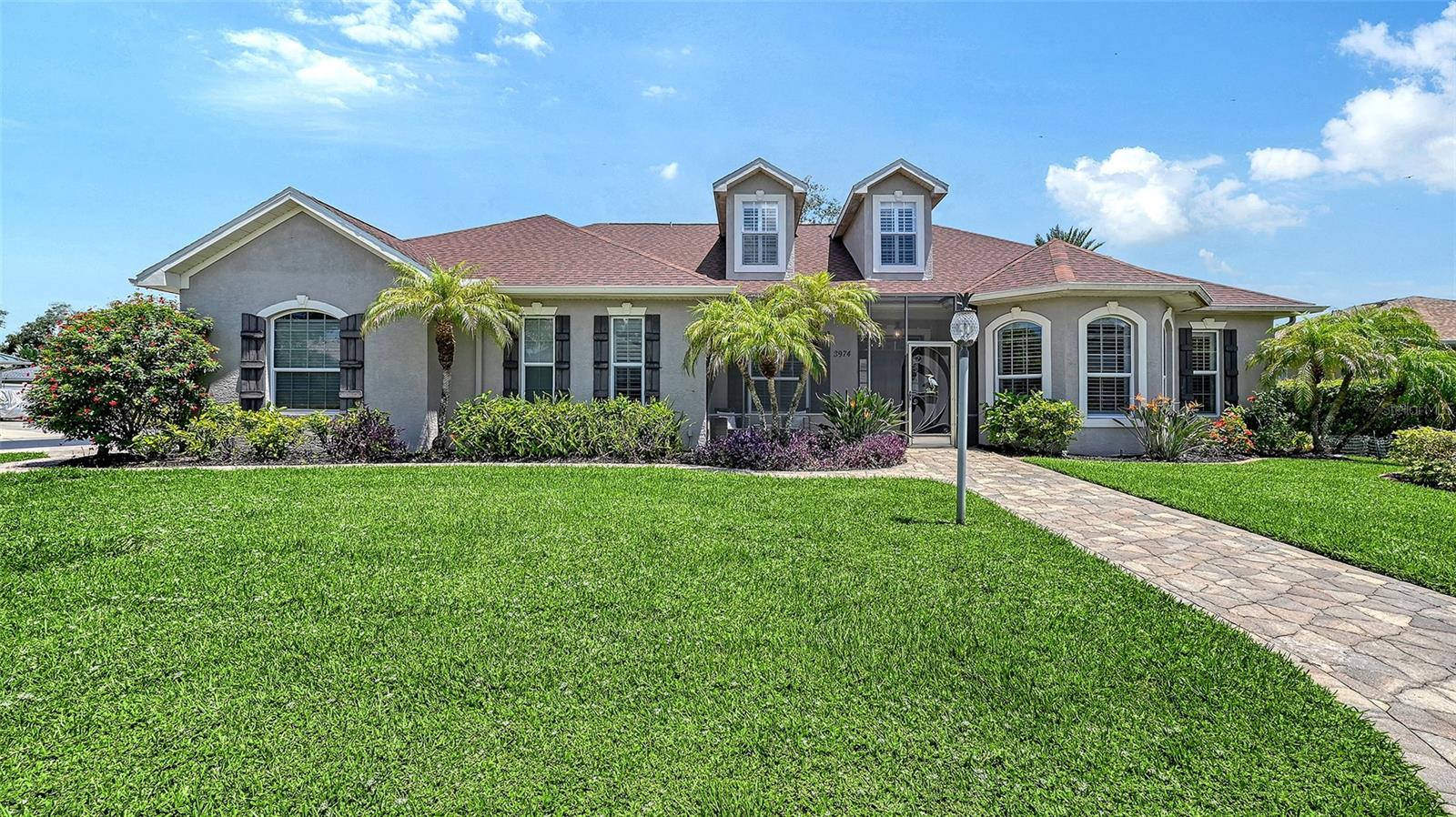 Welcome to this beautifully maintained custom-built home tucked inside an intimate gated community of just 37 homes. Offering a unique and versatile floor plan, this move-in-ready residence is ideal for multigenerational living, extended family, guests, or those seeking additional private living or work space.
Outstanding curb appeal welcomes you with a new paver driveway and walkway, screened front lanai, lush tropical landscaping, and beautiful exterior lighting. Inside, rich walnut flooring, vaulted ceilings, plantation shutters, and elegant molding create a warm and inviting atmosphere. The formal living and dining rooms are perfect for entertaining, while the gourmet kitchen features gorgeous granite countertops, 42-inch cabinetry with LED lighting, stainless steel appliances, and a convenient eat-in area. The kitchen opens to a spacious family room highlighted by a beautiful brick fireplace.
The primary suite offers a relaxing retreat with an en-suite bath featuring dual sinks, a vanity area, jetted garden tub, separate shower, and walk-in closet with built-in organizers. An additional bedroom or den completes the main living area.
A standout feature is the separate living suite with its own entrance, kitchen, bedroom, living area, and full bath—ideal for in-laws, guests, caregivers, or a private home office. Upstairs, the fifth bedroom features charming dormer windows, a Murphy bed, kitchenette, private bath, and bonus playroom or storage area, offering even more flexibility.
Step outside to your own private tropical oasis! The screened lanai overlooks a sparkling saltwater pool with sundeck and waterfall feature, creating the perfect setting for relaxing, entertaining, and enjoying the Florida lifestyle in complete privacy. Multiple rooms open to the outdoor living areas, making indoor-outdoor living effortless.
Additional highlights include a three-car garage with Gladiator storage cabinets and polyaspartic floor coating, a whole-home surge protector, and numerous improvements. Located near the University Parkway corridor, this gated community is approximately 4 miles from Downtown Sarasota, Sarasota-Bradenton International Airport, and UTC shopping, 7 miles from St. Armands Circle and Lido Beach, and 10 miles from Siesta Key Beach. Enjoy convenient access to shopping, dining, and world-class beaches while coming home to your own private retreat!