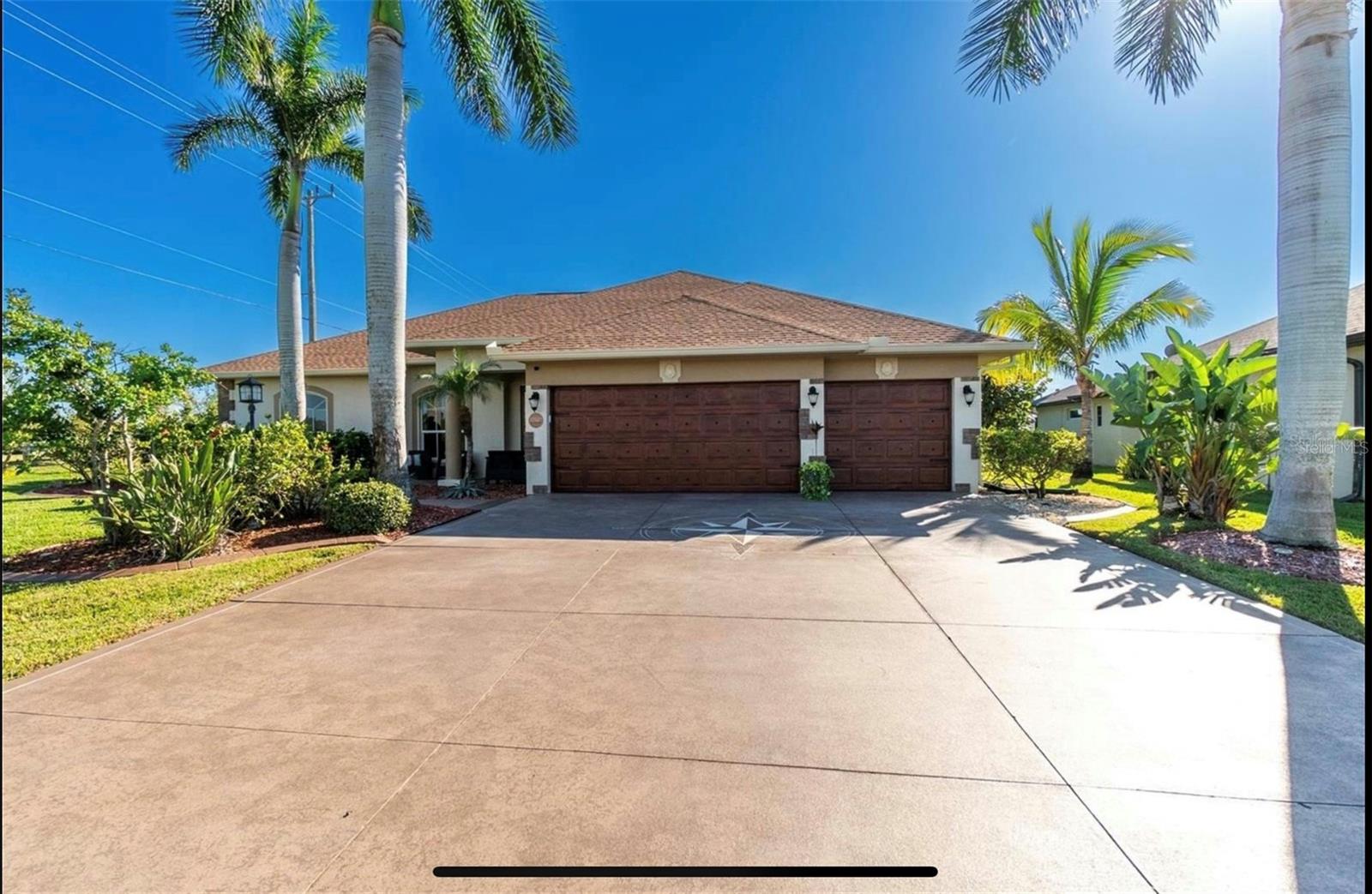 Waterfront living at its best.  This stunning custom-built Fero home is a masterpiece of design, offering luxurious amenities and breathtaking views throughout.  Boasting 4BR, 3 full bath, and a 3 car garage, this residence is a haven of comfort and style.  The mature tropical landscaping envelops the property, the stacked stone accents, oversized decorative etched driveway/sidewalk, lead you to elegance that awaits within.  Step through the entrance into the formal living room, where the allure of the heated swimming pool and waterfront vistas captivate your senses.  Expansive zero-degree 8 ft sliders seamlessly blend indoor and outdoor living spaces, creating harmonious flow.  Volume ceiling, upgraded fixtures, custom remote shades, and a stone wall with built-in cabinets and an electric fireplace elevate the living rooms ambiance.  The remodeled kitchen features solid wood cabinets, Fantasy Brown stone countertop, a subway tile backsplash, a farm-style sink, and a suite of stainless-steel appliances.  This culinary haven opens to the dining room and family room, fostering a perfect atmosphere for entertaining.  The primary suite is a retreat within itself, with 8' sliders leading to the lanai, a sitting area, and an ensuite bathroom boasting a jetted tub, walk-in tile shower, and a dual sink vanity.  The covered lanai provides an ideal space for outdoor living, whether entertaining, dining, or simply relaxing.  A mini summer kitchen equipped with an ice maker, mini fridge, counter and sink.  The entire lanai is paved, offering ample room for sunbathing and enjoying the Florida sun.  The heated Pepple Tec pool includes a sundeck, seat with jets, and a soothing waterfall.  The pool and heater have a new Intellicenter that can be operated by an app on your phone.  For boating enthusiasts, the property offers Gulf access, 90' of seawall, a Trex dock with a built-in fish station, and a 10,000 lb newly covered boat lift.  This waterfront property truly embodies the Florida lifestyle, combining elegance, comfort, and the joy of living by the water.  The 3-car garage has a freshly epoxied floor, pull-down stairs with attic storage, and overhead storage.  The home also features a laundry room, Mana block plumbing, prewire generator, accordion hurricane shutters, hurricane proof garage doors, and electric roll down on lanai, security system, central vac, new irrigation system.  Also new pool heater and water heater May 2026, new roof, A/C and seamless gutters in 2023.  Optional HOA.  Access to 55 miles of canals plus Charlotte Harbor.  Minutes from Englewood, Boca Grande, beaches, restaurants, entertainment, golfing, and shopping.  This home covers it all.  
The property/vacant land across the street is also available for purchase.