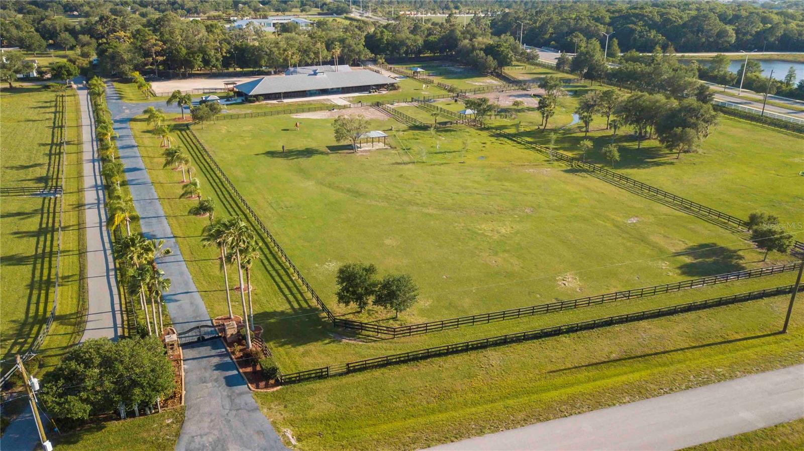 NEARLY 12 ACRES | 22-STALL EQUESTRIAN BARN | GATED SARASOTA POLO CLUB | BUILD YOUR DREAM ESTATE!

An extraordinary opportunity awaits in the exclusive Sarasota Polo Club, nestled in the heart of Lakewood Ranch! Situated on nearly 12 breathtaking acres adorned with majestic oak trees and lush green pastures, this exceptional equestrian property offers the perfect setting to create your dream estate while enjoying the very best of the Florida lifestyle.

Whether you envision building a magnificent custom home, developing a premier equestrian facility, or creating your own private retreat surrounded by majestic oaks and beautiful pastures, this exceptional property offers endless possibilities.

The impressive 22-stall barn has been thoughtfully updated and designed with both horses and their caretakers in mind. Features include fans in every stall, a convenient watering system, a Shoo-Fly insect control system throughout the barn, and an air-conditioned tack room with hot and cold water. Additional amenities include an air-conditioned laundry room and feed room, along with two studio apartments ideal for staff accommodations or flexible workspace. Existing garages provide additional storage and functionality.

Beyond the property, residents of the gated Sarasota Polo Club enjoy a truly unique lifestyle, with scenic riding trails, exciting polo matches, and a wonderful calendar of social events.

LOCATION, LOCATION, LOCATION! Enjoy the tranquility of your private equestrian retreat without sacrificing convenience. Just a short golf cart ride away is the vibrant Waterside Place, offering waterfront dining, boutique shopping, a popular Sunday farmers market, and year-round entertainment. The Lakewood Ranch Golf & Country Club is also just minutes away, offering golf, tennis, dining, and social opportunities. The highly regarded Out-of-Door Academy is conveniently located nearby.

With Sarasota's world-famous beaches, shopping, cultural attractions, and area airports all within easy reach, this property truly offers the best of both worlds.

Nearly 12 acres of privacy, beauty, and equestrian excellence in one of Lakewood Ranch's most distinctive communities. Bring your vision and create the estate you've always dreamed of!