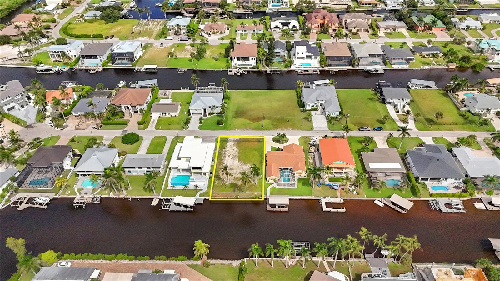 Waterfront lot with endless potential in beautiful Bonita Springs. This vacant southern-exposure property offers wide intersecting canal views and boating access to the Gulf through scenic waterways—an ideal location to build your custom home or investment property. The site previously featured a triplex, providing a unique opportunity for a savvy investor to explore redevelopment potential. Surrounded by new construction and luxury residences, it’s the perfect setting to bring your vision to life—whether you’re creating a forever home, income-producing property, or relaxing coastal retreat. Enjoy serene water views, a quiet neighborhood setting, and easy access to everything Bonita Springs has, including beaches, waterfront dining, shopping, kayaking, and endless Gulf adventures. This is your chance to create something extraordinary—one of the last true waterfront opportunities in this highly sought-after area.