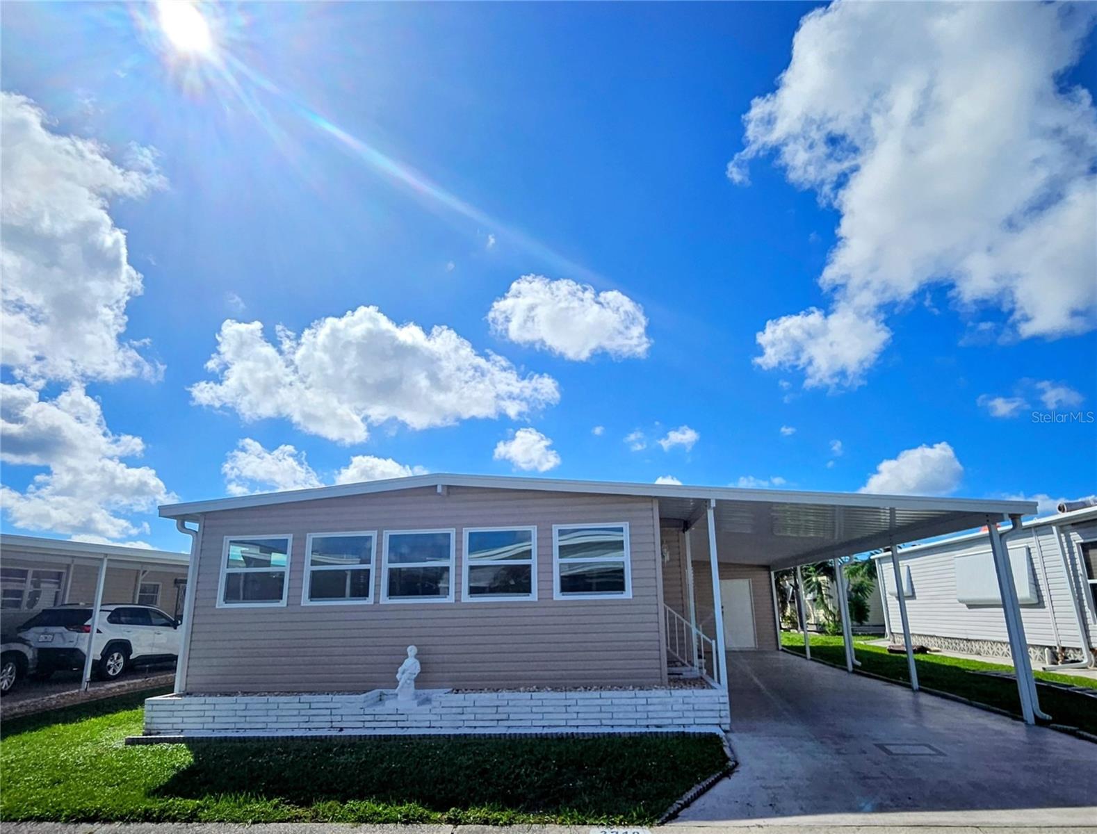Located in the ONLY Resident Owned Resort Style Park in the City limits of Sarasota!! 

This is a lovely 2 bed 2 bath turnkey furnished home offers 1,180sf of living space with the  enclosed Florida room - all under the main AC. The updated floors ( and sub floors) have eye pleasing laminate and tile. 2024 windows (excluding baths) throughout and several structural updates show this home has been loved and cared for by a multi generational family for many years.

THE SPACE: The KITCHEN provides ample cooking and storage cabinets, including a pantry. Appliances include a flat stove, range hood, dishwasher, fridge and microwave. The split plantation shutters in the LIVING room and dining room really dress up the space. Relax and watch your favorite shows on the large flat screen TV.  The DINING room has a family size table with comfortable seating and the built in server/buffet hosting loads of invaluable storage and a long counter top that can serve as a food buffet style space when hosting friends and family. The PRIMARY BEDROOM is spacious with 3 closets and built in drawers! The en suite shower bath gives privacy from the main guest bath.  The GUEST BEDROOM has 2 twin beds ( so plenty of room for a larger bed if desired ) a built in dresser and 2 closets.  The outdoor storage (SHED) houses a washer dryer, the water heater, storage space and an overhead shelf.
The FLORIDA ROOM can be enjoyed year round - refurbished in 2024 and faces North (no afternoon sun beating in the windows). With AC from the main home - this is a great multi use area where one can enjoy reading, a card/game area, office or den - in 2024 the Roof, windows, walls, flooring, entry door and sliding door were all updated. 

UPDATES/AGES: Main ROOF Over TPO 2019 with warranty, 2024 FLORIDA ROOM was rebuilt with new TPO Roof Over with warranty / Windows / Walls / Flooring / Exterior Door / Sliding glass door to living room. 2024 CARPORT was partially replaced and structurally updated to most recent hurricane codes, WINDOWS replaced 2024 (excluding baths), HVAC was replaced 2022 with warranty and serviced 10/2026, SKIRTING replaced 2024, 40 gal Rheem WATER HEATER was relocated to the shed. SEWER line replaced to the pea trap. Home was tented in 2018.
**Please check with each vendor regarding their transfer requirements and continued warranty programs for buyer.**

COMMUNITY FEATURES: The gated 90 acre community boasts a low maintenance fee with its vast amenities, starting with the spacious Clubhouse outfitted with a full commercial cook kitchen, event stage, audio/visual, dance floor, state of the art fitness room, activities hall, library with books/movies/puzzles and a pool table. Outside recreation includes an extra large heated pool with a handicap ramp, a spacious kidney shaped hot tub, ample umbrella tables and lounge chairs and updated shower rooms. Oak trees shade the beautiful park area, picnic tables and a community grill. Additional amenities to enjoy are the community putt putt course, bocce ball, ping pong and corn hole. Oakwood Manor is a vibrant community with numerous social events and activities. It is conveniently located adjacent to Legacy Trail and 12 newer pickle ball courts. Just a short drive to our crystal sand beaches, downtown area, the marina, fishing pier, local golf courses, shopping, variety of restaurants, the museum, SRQ airport, SMH and Doctors hospitals. Please note that Oakwood is a 55+, no pet, no motorcycle Park.