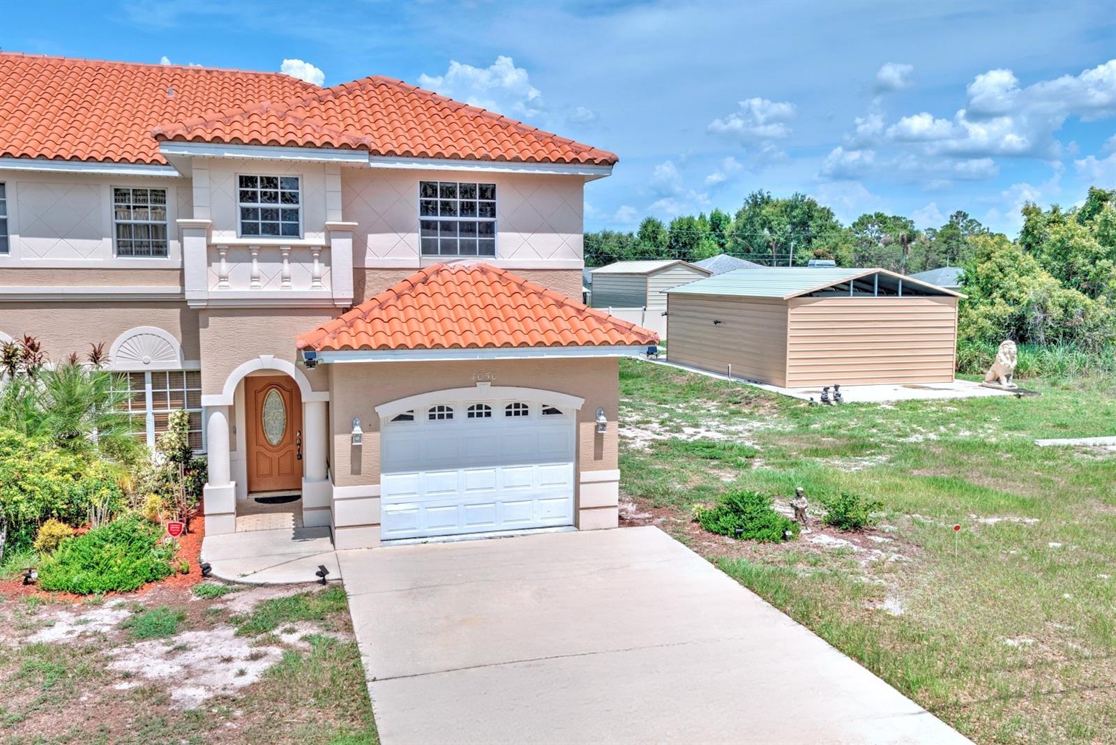 This unique opportunity sits in the scenic Placid Lakes community of Lake Placid. The tile-roofed townhome showcases distinctive architectural features, over 1,924 living square feet, and no HOA. The interior offers a bright, large open living room with all tile flooring on the main level, a convenient half bathroom for guests, and a kitchen tucked toward the back with granite counters. A lovely lanai overlooks the backyard, providing a peaceful space. All three bedrooms are generously sized, with the primary bedroom featuring a private bathroom for added comfort. Extras include the adjacent parcel with a metal building on a concrete slab, complete with its own water and power connections. The seller is currently storing a camper on the extra lot, highlighting the additional storage and toy-ready potential this property offers. This home is well-maintained, spacious, and ready for you to make it your own. Don’t miss the opportunity to schedule a viewing and see why this Placid Lakes gem could be your next dream residence.