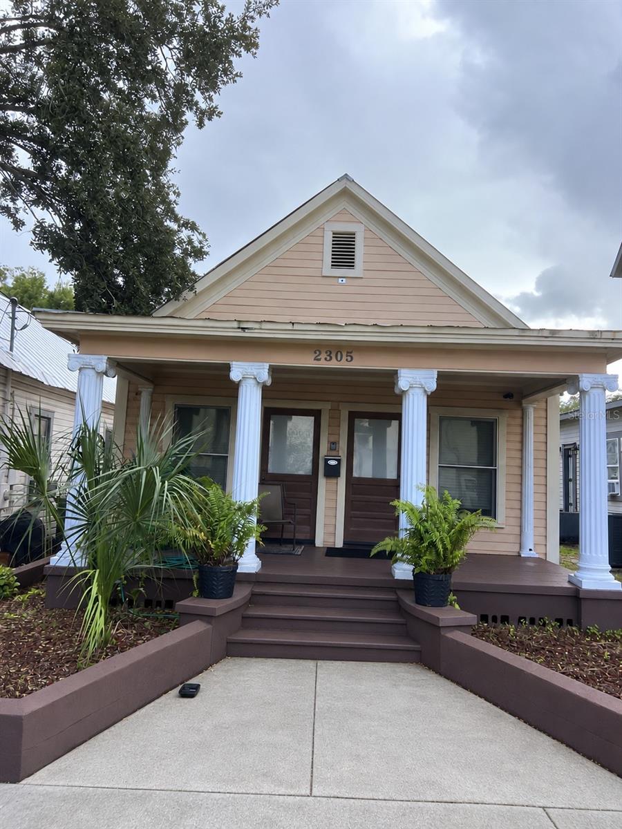 Virtually Staged. HISTORIC YBOR CITY CHARM WITH RESIDENTIAL AND COMMERCIAL POSSIBILITIES! Built in 1924, this beautifully renovated shotgun-style property captures the architectural character and rich history of Ybor City while offering the functionality of a modern professional office. Extensively remodeled in 2011, the 1,128-square-foot building showcases stunning natural wood beadboard walls and ceilings, elegant crown moldings, hardwood floors, high ceilings, oversized wood and glass doors, and an abundance of windows that fill the interior with natural light. Currently configured as professional office space, the layout features three generously sized private offices, a welcoming front reception area, a full bathroom with shower, and a convenient kitchen/copy room equipped with a refrigerator but no stove. Electrical, plumbing, and air conditioning systems were upgraded as part of the renovation, and an alarm system was installed. Situated on a 2,375-square-foot lot at the corner of E 5th Avenue and N 23rd Street, the property also offers 2–3 gated onsite parking spaces, a valuable feature in this historic urban setting. ZONED YC-7, ALLOWING BOTH RESIDENTIAL AND PROFESSIONAL OFFICE USE! Currently classified as single-family residential by the City of Tampa, the property has been utilized as professional offices since its 2011 renovation. Whether you're envisioning a distinctive residence, professional office, or a combination of living and working space, this property's versatility opens the door to exciting possibilities. Located in the heart of Ybor City's vibrant business district, just minutes from Downtown Tampa, the Channel District, restaurants, entertainment, and major transportation corridors. A unique opportunity to own a piece of Tampa's architectural history with the flexibility to make it your own!
