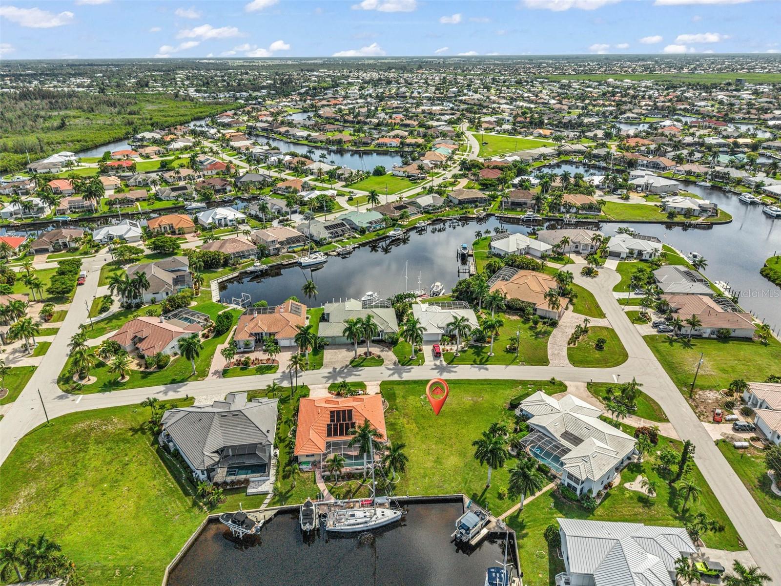 SAILBOAT WATER ACCESS LOT with CONCRETE SEAWALL IN PUNTA GORDA ISLES Prime waterfront opportunity with wide, open water view! This build-ready, vacant lot in Punta Gorda Isles offers 40 feet of city-maintained concrete seawall and immediate sailboat access to Charlotte Harbor—no bridges, no delays. Located on a quiet, cul-de-sac street, this lot is surrounded by custom-built homes and is ready for your custom, dream home. Enjoy a west facing rear exposure with colorful sunsets and abundant natural light across your future lanai or outdoor living area. With the opening of Buckley’s Pass in 2020, you can now reach open water in under 20 minutes. City water and sewer are available. Enjoy a wonderful, wide canal view while watching boats pass by throughout the day. Now's your chance to own a premium sailboat-access lot in PGI — ideal for avid boaters and those planning to build their retirement home in a well-established waterfront community. Don't miss your opportunity to claim your place in paradise.