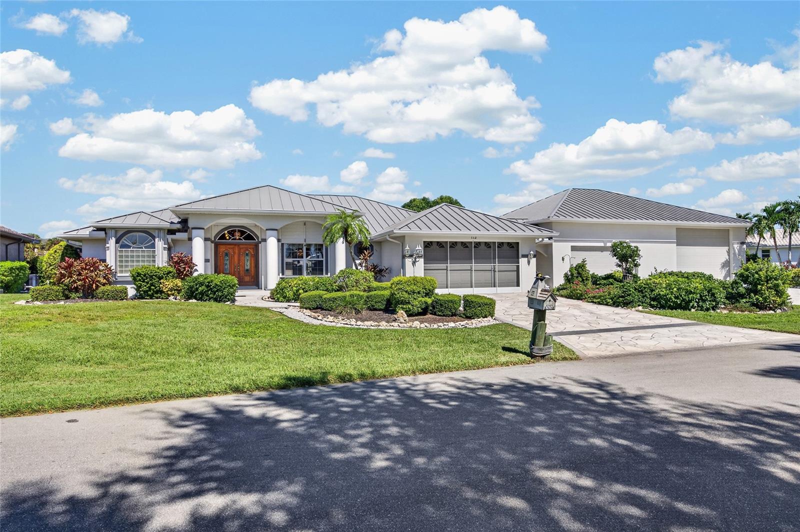 Welcome to this extraordinary Punta Gorda Isles retreat, where 169 FEET OF SALTWATER CANAL FRONTAGE, A PRIVATE POOL, AND AN IMPRESSIVE 6-CAR GARAGE CAPACITY create a rare opportunity to enjoy the Florida lifestyle without compromise! Situated across TWO FULL LOTS, this beautifully maintained 3-bedroom + office, 2.5-bathroom residence offers the perfect combination of waterfront elegance, modern comfort, and incredible flexibility for boating enthusiasts, car collectors, and those who simply appreciate room to live.

From the moment you arrive, lush tropical landscaping and beautiful double-door entryways set the tone for what awaits inside. Step into a bright, inviting interior where SOARING CATHEDRAL CEILINGS, NEW FLOORING, AND AN EXPANSIVE OPEN FLOOR PLAN create an effortless flow throughout the home. The spacious great room offers a wonderful setting for entertaining, while the formal dining room provides an elegant space for memorable gatherings. At the heart of the home, the generously sized kitchen features abundant cabinetry, ample workspace, and a charming dining area overlooking the tranquil canal. A dedicated office with built-in cabinetry offers a comfortable, functional space for working from home or pursuing your favorite hobbies.

Step outside and discover your own PRIVATE WATERFRONT PARADISE! The NEW LANAI surrounds a sparkling swimming pool, complemented by beautiful paver decking, an outdoor shower, and convenient poolside bathroom access. Whether enjoying a quiet morning overlooking the water or hosting friends for an afternoon by the pool, this outdoor oasis was designed for year-round enjoyment. Beyond the lanai, 169 FEET OF SALTWATER CANAL FRONTAGE and a private dock invite you to embrace the boating lifestyle, with access to open water approximately 15 minutes away!

What truly sets this property apart is its EXTRAORDINARY GARAGE AND WORKSPACE CAPACITY! In addition to the attached 2-car garage, a separate DETACHED 4-CAR GARAGE provides exceptional room for vehicles, recreational equipment, tools, and treasured collections. Complete with a dedicated AIR-CONDITIONED OFFICE SPACE, custom storage, and flexible areas for hobbies or projects, this impressive secondary structure opens the door to endless possibilities. With TWO FULL LOTS, there is room to spread out and enjoy the versatility that makes this property so special.

Thoughtful improvements add even more appeal, including a NEW METAL ROOF (2023), NEW FLOORING, NEW LANAI, UPDATED ELECTRICAL PANEL, AND STORM PROTECTION featuring impact windows and electric roll-down shutters.

Perfectly positioned in desirable Punta Gorda Isles, just minutes from downtown Punta Gorda's waterfront dining, shopping, parks, and entertainment, this remarkable property offers far more than a beautiful place to call home. IT'S A WATERFRONT LIFESTYLE WITH ROOM FOR EVERYTHING YOU LOVE!