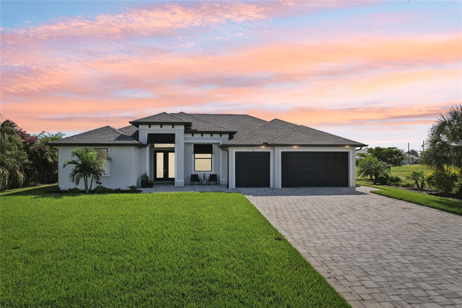 Luxury Canal Front Pool Home with Sunset Views, Three-Car Garage, Hurricane Protection, and the Structure in the X Flood Zone in Rotonda West! Discover exceptional waterfront living in this 3 bedroom, 3 bathroom DM Dean-built home with a heated pool and spa, three-car garage, and approximately 80 feet of freshwater canal frontage. This designer turnkey furnished home combines quality craftsmanship, thoughtful design, and extensive upgrades while offering western exposure with beautiful sunset views. A paver driveway, tropical landscaping, Bahama shutters, and leaded glass double front doors create an impressive first impression. Inside, custom tile flooring extends throughout the home, complemented by tray ceilings with crown molding, motorized light-filtering and blackout blinds, and an open great room with zero-corner sliding glass doors that open to the lanai, pool, and canal beyond. The kitchen is designed for everyday living and entertaining, featuring quartz countertops, custom slate gray cabinetry with pull-out shelving, under-cabinet lighting, a designer Blanco sink, pot filler, beverage cooler, premium stainless steel appliances, a large pantry, and an oversized island with breakfast bar seating. The adjoining dining area overlooks the pool and waterfront, creating the perfect setting for everyday meals or entertaining guests. The spacious primary suite features private sliding glass door access to the lanai, two walk-in closets plus an additional reach-in closet, and an ensuite bathroom with separate quartz-topped vanities, a six-foot freestanding soaking tub, and a walk-in shower. The split bedroom floor plan provides privacy for family and guests with two additional bedrooms, including one ensuite, while both guest bathrooms offer quartz countertops, additional cabinetry, and walk-in showers. A dedicated office with frosted glass double doors and transom windows provides an ideal workspace, while the laundry room includes a utility sink and storage closet. The outdoor living area was designed to enjoy Florida year-round with a heated pool and spa, sun shelf, spacious covered lanai, canal views, and a custom lanai lighting system that creates the perfect evening ambiance. The space is already pre-plumbed for a future outdoor kitchen, allowing you to easily create your own outdoor entertaining area while enjoying peaceful waterfront surroundings and spectacular sunset views. Additional features include a three-car garage with epoxy flooring and finished walls, hurricane impact windows, doors, and sliders, foam insulation, additional sound insulation in the bedroom walls, generator wiring, alarm sensors on all exterior openings, and a three-zone air conditioning system with ultraviolet light and an extended transferable warranty. Located in the deed-restricted community of Rotonda West, residents enjoy approximately 26 miles of scenic canals, ponds, and lakes, multiple golf courses, parks, walking and biking trails, abundant wildlife, and a variety of community activities. Beautiful Englewood Beach, Boca Grande, boating, fishing, shopping, dining, medical facilities, and Major League Spring Training stadiums are all just a short drive away. Discover everything this exceptional waterfront home has to offer at 35 Medalist Court in Rotonda West.