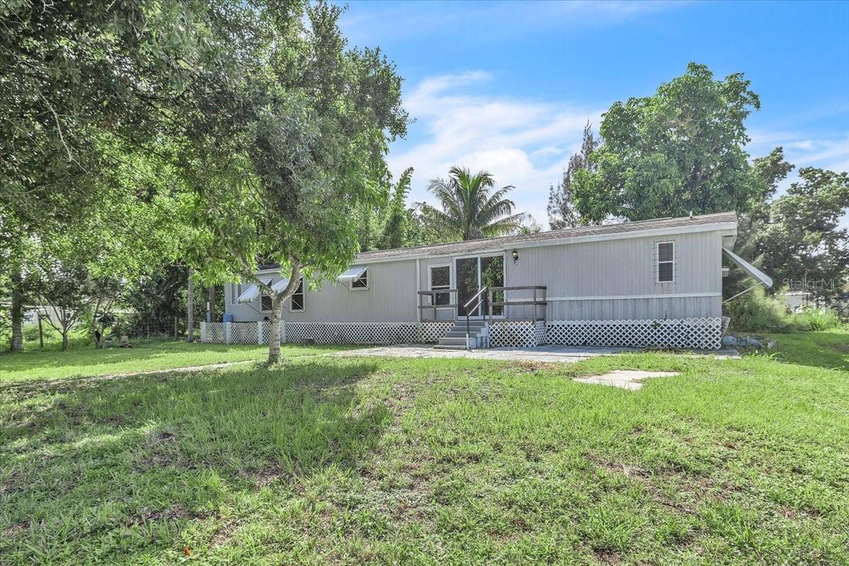 Virtually Staged. Welcome to South Punta Gorda Heights, where this 3-bedroom, 2-bath single-wide mobile home offers a great opportunity to create your own Florida retreat. Situated on an 8,150-square-foot freshwater canal lot, this 1991-built home features 924 square feet of living space and plenty of potential for a buyer ready to add their own personal touches and updates. Inside, the home features a comfortable great-room layout with an easy flow between the main living areas. Ceramic tile and laminate flooring provide practical, low-maintenance surfaces throughout. The primary bedroom offers its own private bath, while two additional bedrooms and a second full bathroom provide flexible space for family, guests, a home office, or hobbies. Outdoor living is a highlight with an expansive 41' x 12' covered and screened rear lanai overlooking the freshwater canal—a relaxing setting for morning coffee, casual dining, or enjoying the Florida weather. A 13' x 10' utility building located under roof provides additional space for storage, tools, or recreational equipment. Conveniently located approximately 2 miles from shopping and Interstate 75 and about 6 miles from historic downtown Punta Gorda, the property offers easy access to restaurants, waterfront parks, entertainment, boating, fishing, and all that Southwest Florida has to offer. With its freshwater canal setting, spacious screened lanai, three-bedroom layout, and convenient location, this property offers plenty of possibilities for a full-time residence, seasonal getaway, or investment opportunity. Bring your ideas and make this South Punta Gorda Heights property your own.