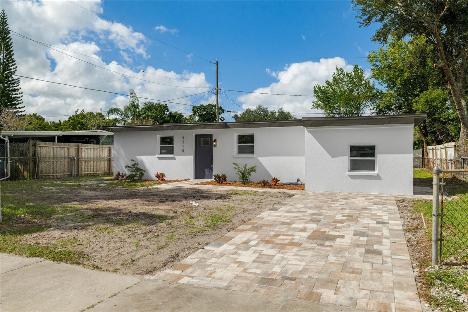 Virtually Staged. ***Seller is offering up to 5% TOWARD BUYER CLOSING COSTS AND/OR INTEREST RATE BUYDOWN with an accepted full-price offer***BEAUTIFULLY UPDATED TAMPA HOME WITH PRIVATE IN-LAW SUITE AND NO HOA! Welcome to 3215 Welborn Way, a charming 3-bedroom, 2-bathroom home offering modern finishes and a versatile layout designed for comfort and convenience! Step inside to discover a bright, inviting interior featuring beautiful laminate and luxury vinyl flooring, contemporary finishes, and an OPEN-CONCEPT LIVING AND KITCHEN AREA perfect for everyday living and entertaining. The kitchen features SOLID WOOD CABINETRY, SOLID SURFACE COUNTERTOPS, and a functional design that brings style and practicality together. ONE OF THIS HOME'S STANDOUT FEATURES IS THE ATTACHED IN-LAW SUITE, complete with its own PRIVATE ENTRANCE, BEDROOM, AND BATHROOM! This flexible living arrangement is ideal for extended family, visiting guests, multigenerational living, or anyone looking for additional privacy and independence. Outside, enjoy a SPACIOUS YARD offering plenty of room for weekend cookouts, outdoor gatherings, gardening, or creating your own backyard retreat. The extended driveway provides convenient off-street parking, while the NO HOA adds even more flexibility! LOCATION IS A MAJOR PLUS! Conveniently situated in Tampa, this home offers easy access to Brandon, Riverview, Downtown Tampa, I-75, US-301, and the Selmon Expressway, connecting you to shopping, dining, entertainment, and major employment centers throughout the Tampa Bay area. With its UPDATED INTERIOR, PRIVATE IN-LAW SUITE, FLEXIBLE LIVING SPACES, AND GENEROUS OUTDOOR SPACE, this home offers an incredible opportunity for comfortable Florida living. Don't miss your chance to make 3215 Welborn Way your own! Schedule your private showing today!