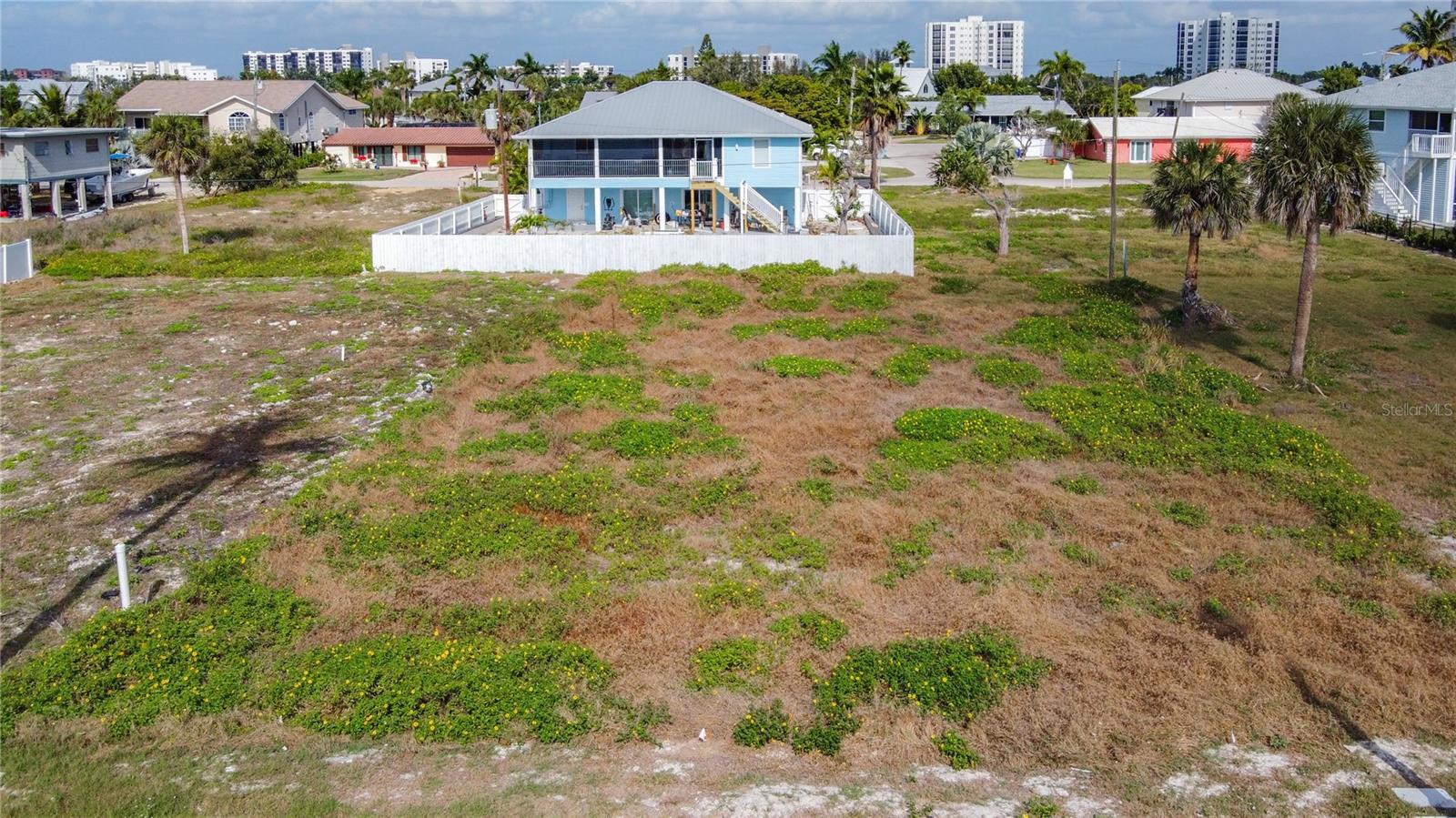 Located at 8033 Estero Blvd., Fort Myers Beach, FL 33931, this residence delivers coastal living with an Exceptional Gulf-Access Homesite, Weekly Rentals Permitted. Located in the charming Laguna Shores community on Estero Boulevard, at the highly desirable south end of Fort Myers Beach, this premier parcel offers an unparalleled opportunity to build a custom island retreat or income-producing coastal residence. Positioned directly across the boulevard from the white sugar-sand beaches of the Gulf of Mexico, the property includes deeded beach access just steps away—allowing you to enjoy breathtaking sunsets and the ultimate beach lifestyle every day. The lot is fully prepared with utilities in place, making it ready for construction. Spanning nearly a quarter acre, there is ample space to design a luxury coastal home complete with a private pool and outdoor living areas. Weekly/short-term rentals are permitted, providing excellent flexibility for personal use, investment income, or future development. This prime location places you near some of Fort Myers Beach’s most exciting destinations, including Santini Plaza, Publix, CVS, and the newly opened Jimmy Buffett’s Margaritaville Resort. Enjoy easy access to island dining, boutique shopping, live entertainment, boating, fishing, jet skiing, kayaking, and the high-speed Key West ferry. Golf, tennis, and boat rentals are also nearby. Convenient on-and-off island access allows for quick drives to Naples, Bonita Springs, Estero, and Fort Myers, with RSW International Airport approximately 30 minutes away and Punta Gorda about 45 minutes. Whether you’re envisioning a private island escape, a luxury vacation rental, or a long-term investment in one of Southwest Florida’s most sought-after coastal markets, this homesite delivers location, lifestyle, and income potential—all in one extraordinary offering. Create your masterpiece and embrace the very best of beach living. INFORMATION IS DEEMED RELIABLE BUT NOT GUARANTEED…TO BE VERIFIED BY THE BUYER AND/OR BUYER'S AGENT, INCLUDING UTILITIES.