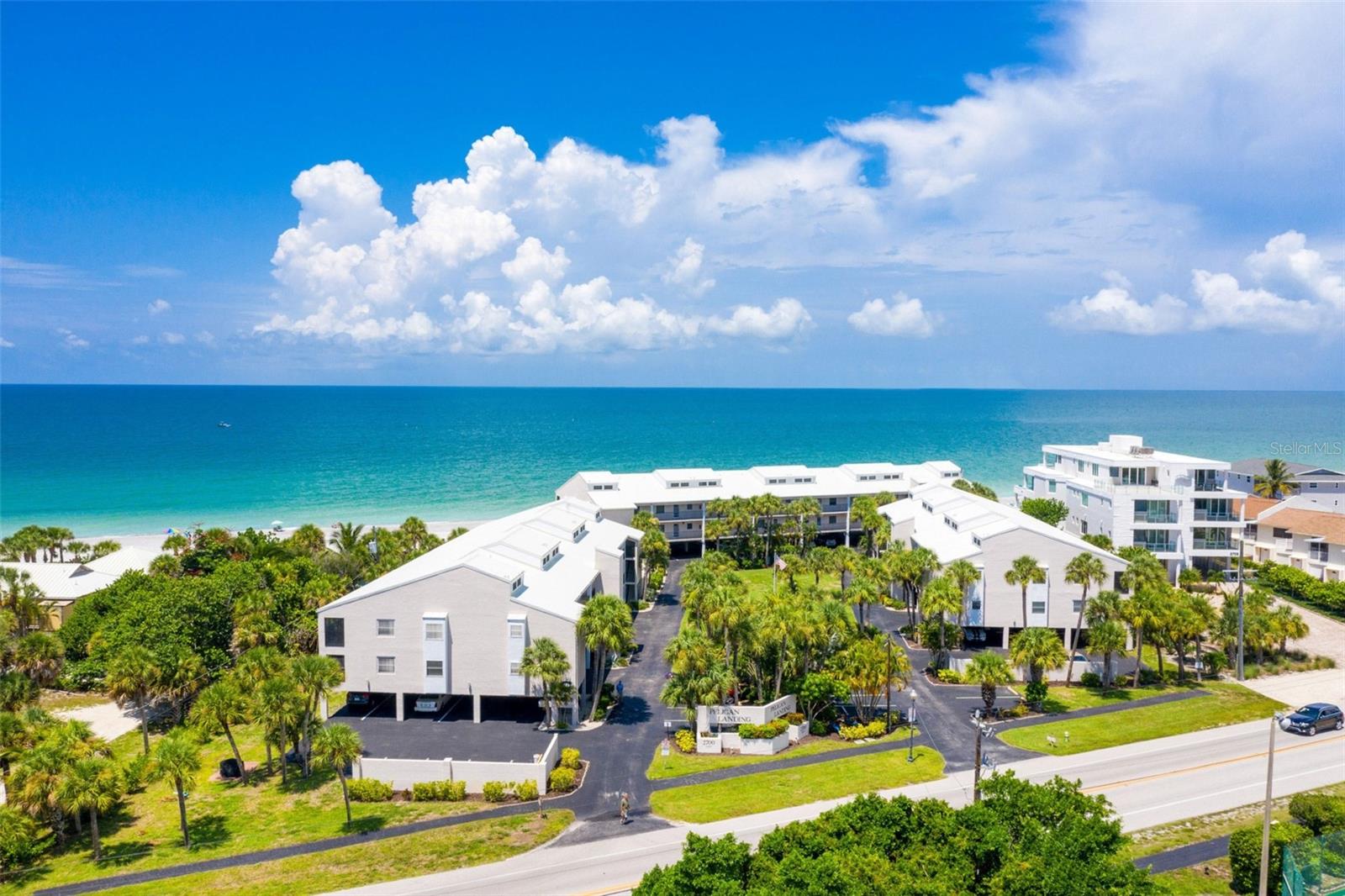 If you have been looking for beachfront living, then look no further. PELICAN LANDING ON MANASOTA KEY is a Gulf-to-Bay condominium community where the Gulf and Lemon Bay are both part of your Florida lifestyle. Located on the Gulf side of the community, this 2-bedroom, 2-bath condominium features an expanded living area with an enclosed lanai, a peek-a-boo GULF VIEW from the kitchen window, ELEVATOR ACCESS, and convenient UNDER-BUILDING COVERED PARKING. The light and bright interior offers an open living and dining area, tile flooring throughout the main living spaces, white kitchen cabinetry, beautiful counters, a spacious breakfast bar, and an in-unit stacked washer and dryer. Step outside and enjoy approximately 285 FEET OF PRIVATE BEACH ACCESS along the Gulf, perfect for morning walks, searching for shells and shark teeth, or watching spectacular Southwest Florida sunsets. Pelican Landing offers an impressive collection of amenities spanning from the Gulf to Lemon Bay, including a BEACH-SIDE HEATED SWIMMING POOL AND SITTING AREA, CLUBHOUSE, TENNIS COURTS, COMMUNITY BOAT DOCKS, and FISHING PIER. Elevator access and under-building parking add everyday convenience to island living. The community continues to be refreshed, with NEW RAILINGS already installed and PARKING LOT RESURFACING currently underway. Manasota Key is open and ready to enjoy, with Englewood Beach, local restaurants, and island businesses nearby. Beyond the Key, you are close to shopping, fabulous local dining, golf courses, and everything the greater Englewood area has to offer. Boating and world-class fishing are at your doorstep, with Lemon Bay, the Intracoastal Waterway, and the Gulf all within easy reach. Whether spending the day on the beach, boating the waterways, dining on Manasota Key, or simply enjoying the Gulf breeze from home, 2700 N Beach Road #A105 offers the opportunity to experience the coastal Southwest Florida lifestyle at PELICAN LANDING ON MANASOTA KEY.