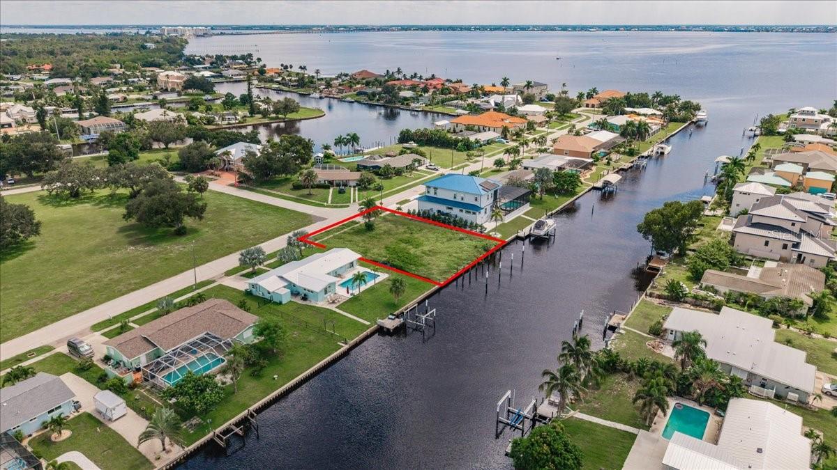 BUILD YOUR FLORIDA DREAM HOME ON THIS OVERSIZED SAILBOAT-WATERFRONT LOT IN PORT CHARLOTTE! Located at 182 Severin Rd SE, this CLEARED 0.29-ACRE homesite offers an impressive 100 FEET OF WATERFRONT with a CONCRETE SEAWALL already in place and DIRECT SAILBOAT ACCESS to Charlotte Harbor and the Gulf of Mexico. With no bridges to navigate, this property is an excellent opportunity for boating enthusiasts looking to enjoy Southwest Florida’s exceptional boating, fishing, and waterfront lifestyle. PUBLIC UTILITIES ARE AVAILABLE, adding convenience when it comes time to build your custom home. The generous homesite provides plenty of space to incorporate outdoor living areas, a pool, and a dock to take full advantage of the waterfront setting. Situated on a DEAD-END STREET with Severin Park directly across the street, the property offers a desirable setting while remaining convenient to shopping, dining, medical facilities, Port Charlotte Beach Park, downtown Punta Gorda, and other area amenities. Whether you're ready to build your waterfront dream home or searching for a prime piece of Southwest Florida real estate to add to your investment portfolio, this cleared sailboat-access lot with 100 feet of waterfront, an existing concrete seawall, and public utilities available offers an exceptional opportunity to own your piece of Southwest Florida paradise!